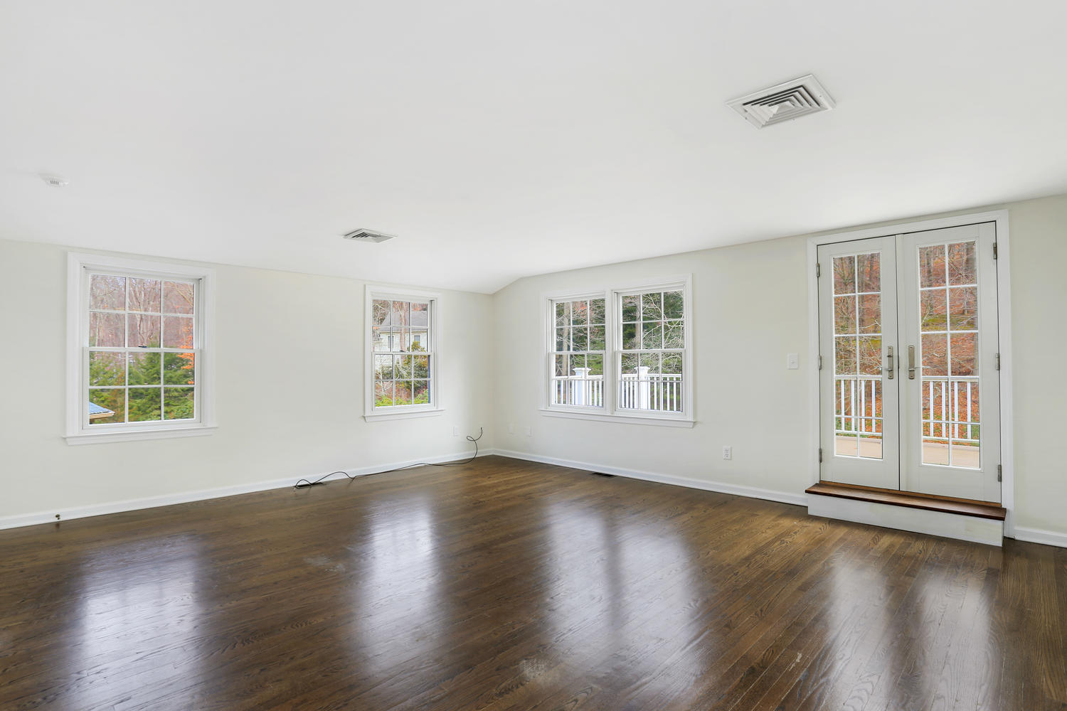 129 Hickok Road New Canaan, CT 06840 - Photo 17 of 32 a view of an empty room with wooden floor and a window