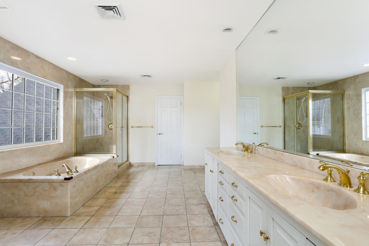 129 Hickok Road New Canaan, CT 06840 - Photo 21 of 32 a spacious bathroom with a double vanity sink large mirror and a bathtub