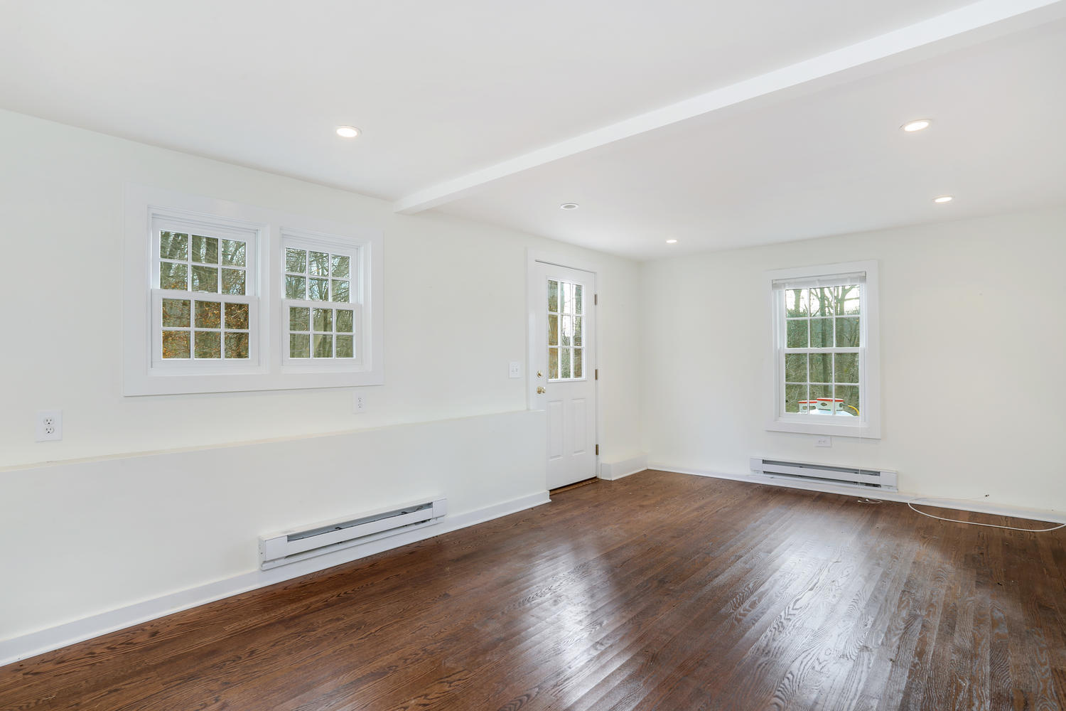 129 Hickok Road New Canaan, CT 06840 - Photo 26 of 32 an empty room with wooden floor and windows