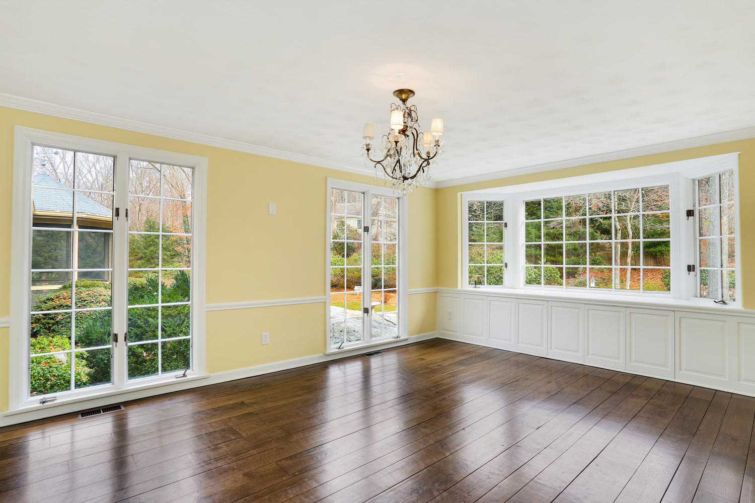 129 Hickok Road New Canaan, CT 06840 - Photo 8 of 32 a view of an empty room with wooden floor and a window