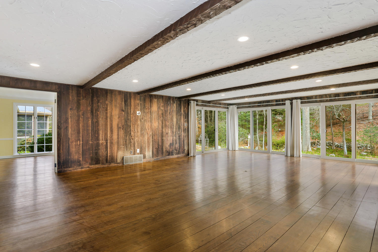 129 Hickok Road New Canaan, CT 06840 - Photo 9 of 32 a view of an empty room with wooden floor and a window