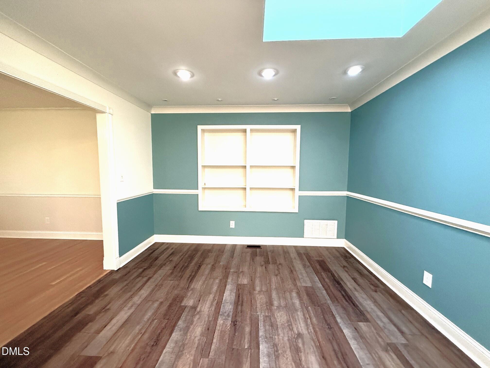 4108 Pleasant Grove Church Road Raleigh, NC 27613 - Photo 13 of 38 a view of empty room with wooden floor and fan