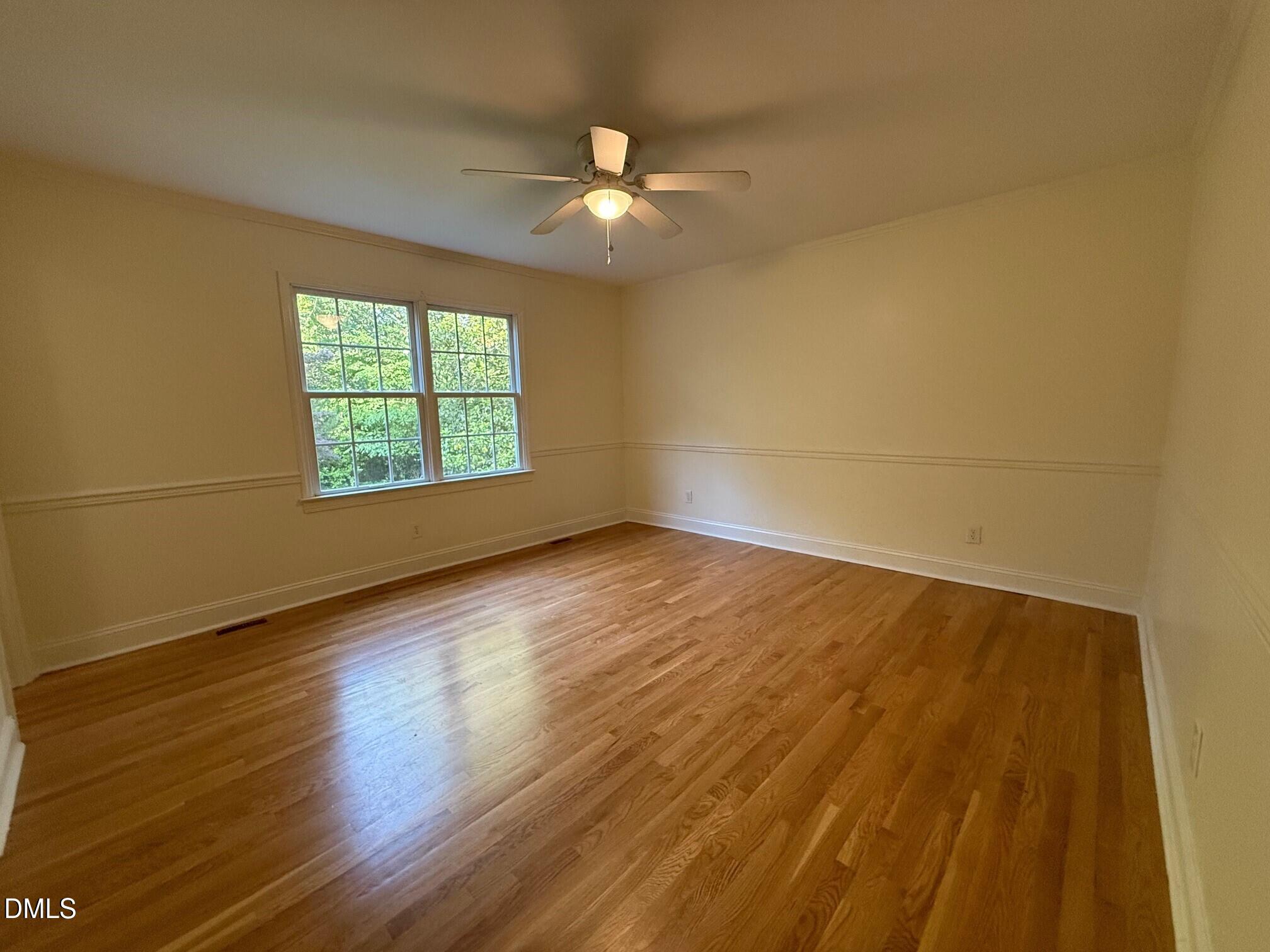 4108 Pleasant Grove Church Road Raleigh, NC 27613 - Photo 17 of 38 a view of an empty room with wooden floor and a window