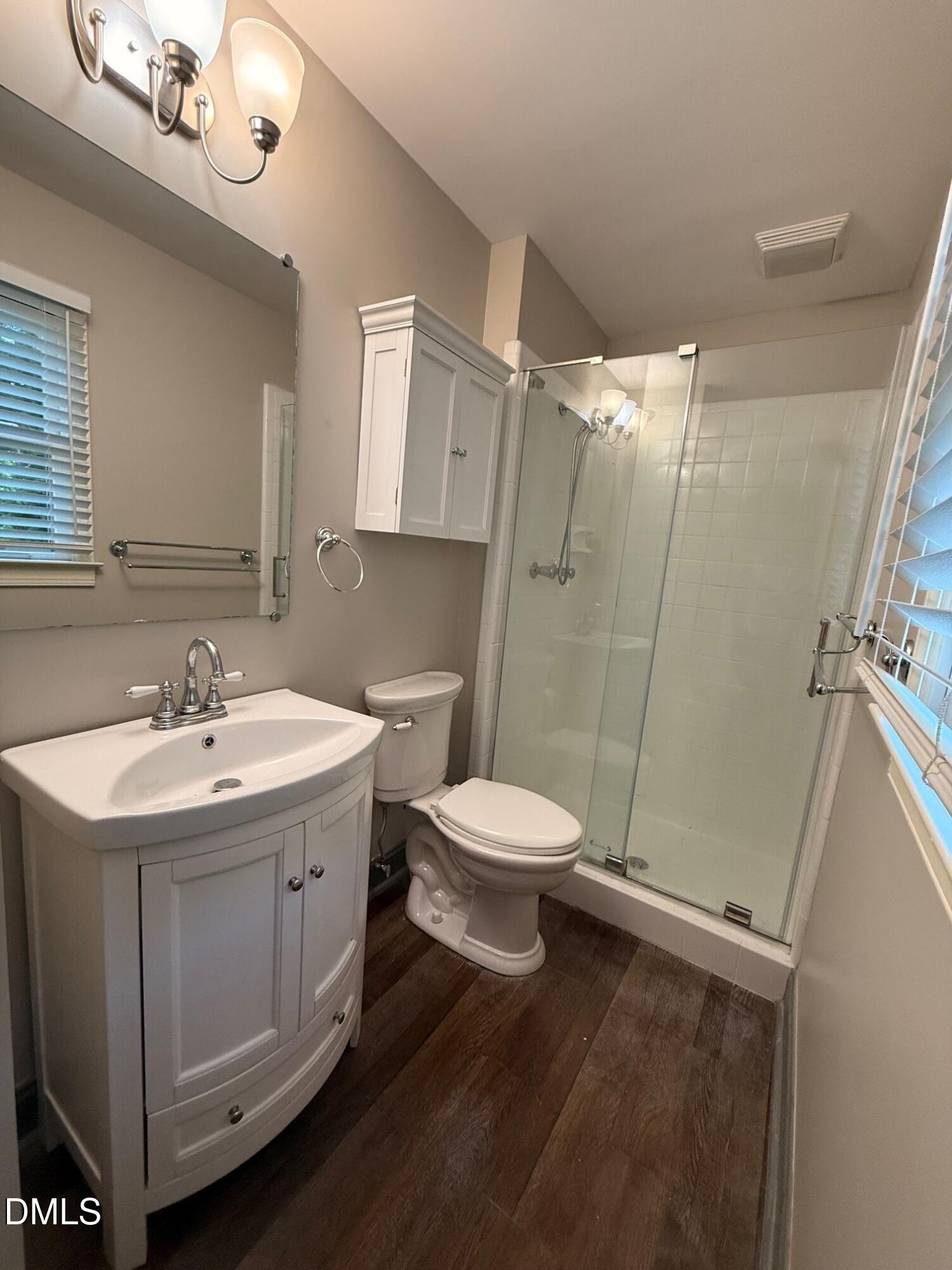 4108 Pleasant Grove Church Road Raleigh, NC 27613 - Photo 18 of 38 a bathroom with a sink a toilet a mirror and shower
