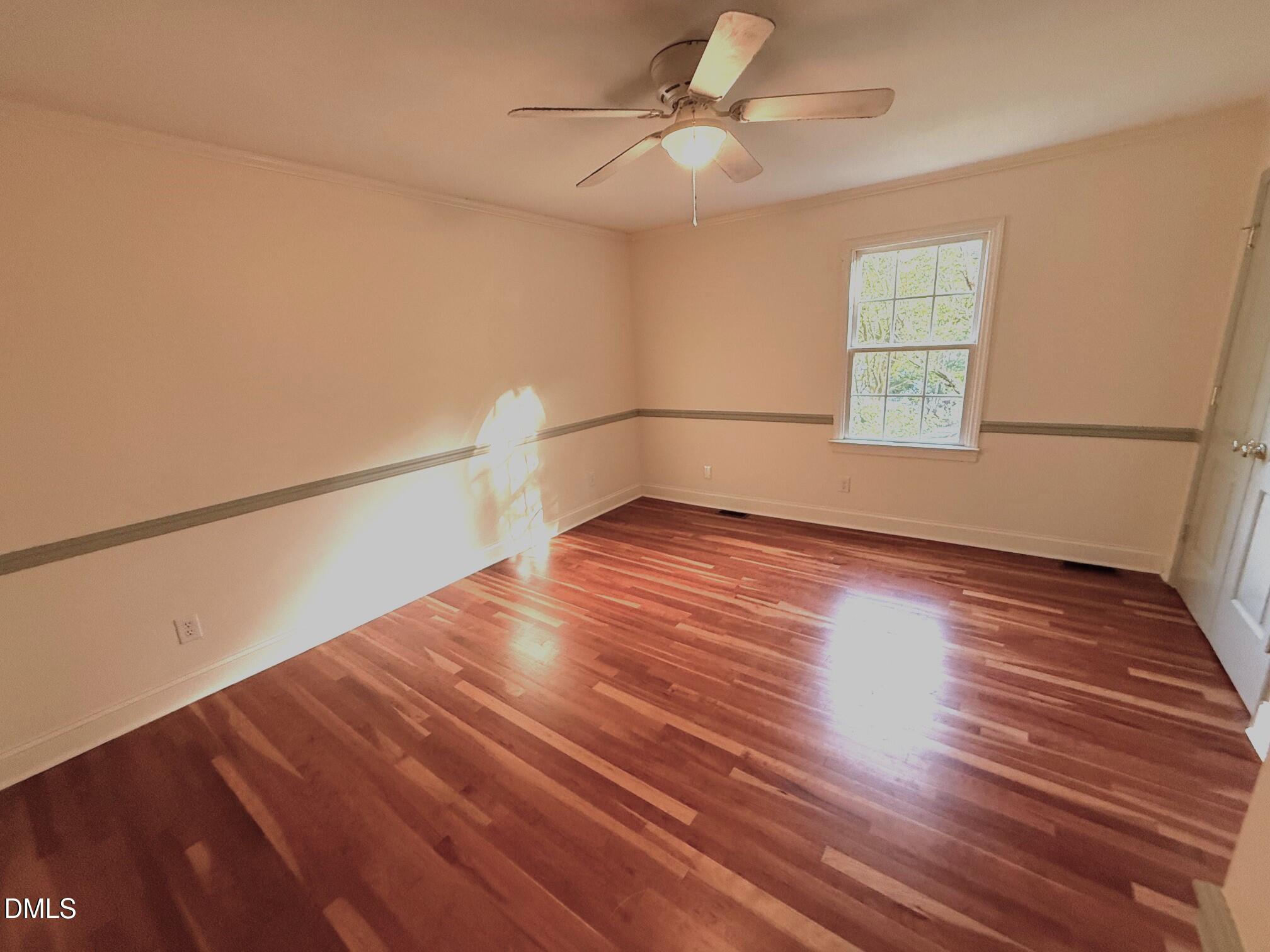 4108 Pleasant Grove Church Road Raleigh, NC 27613 - Photo 19 of 38 a view of empty room with wooden floor and fan