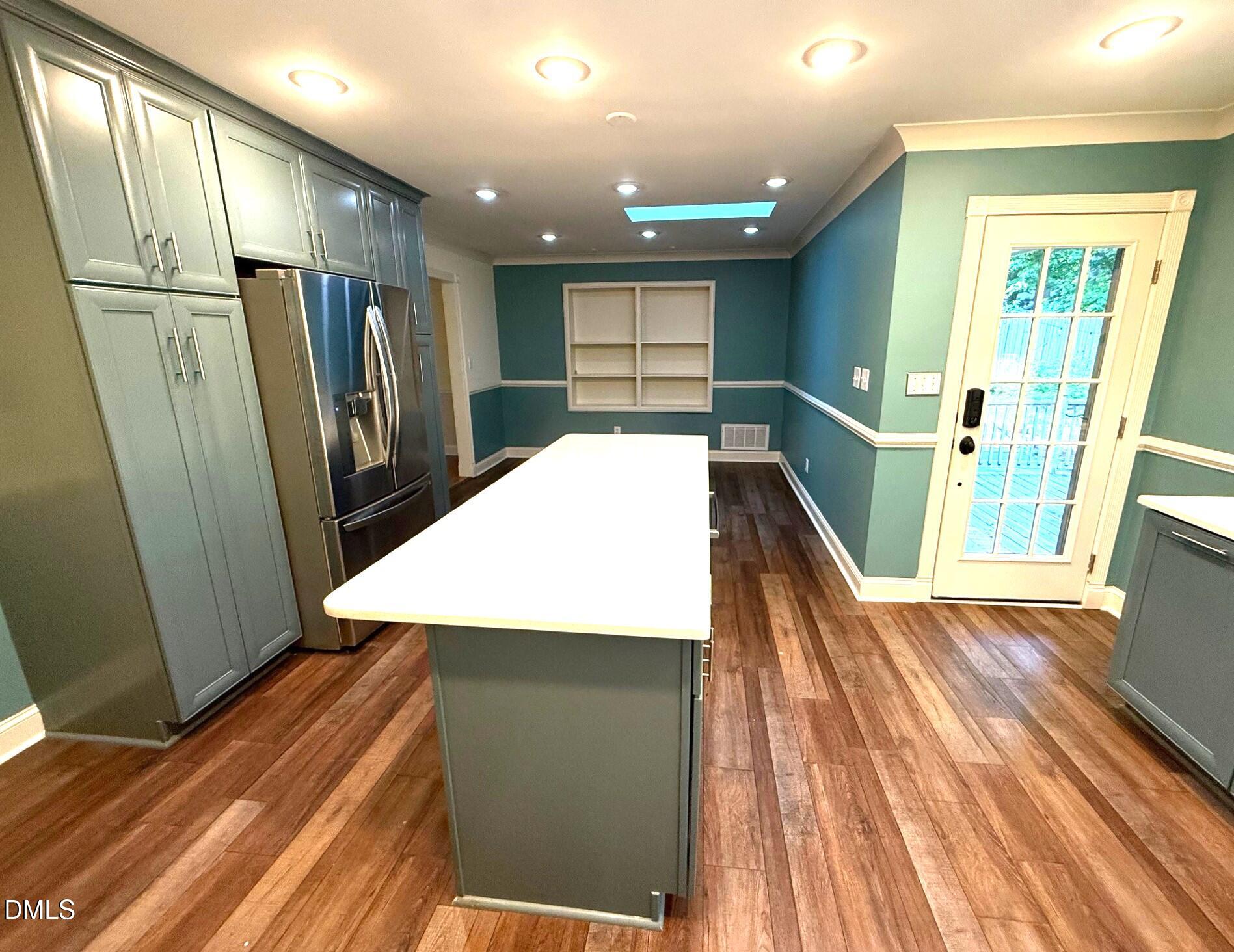4108 Pleasant Grove Church Road Raleigh, NC 27613 - Photo 2 of 38 a view of kitchen with refrigerator microwave and wooden floor