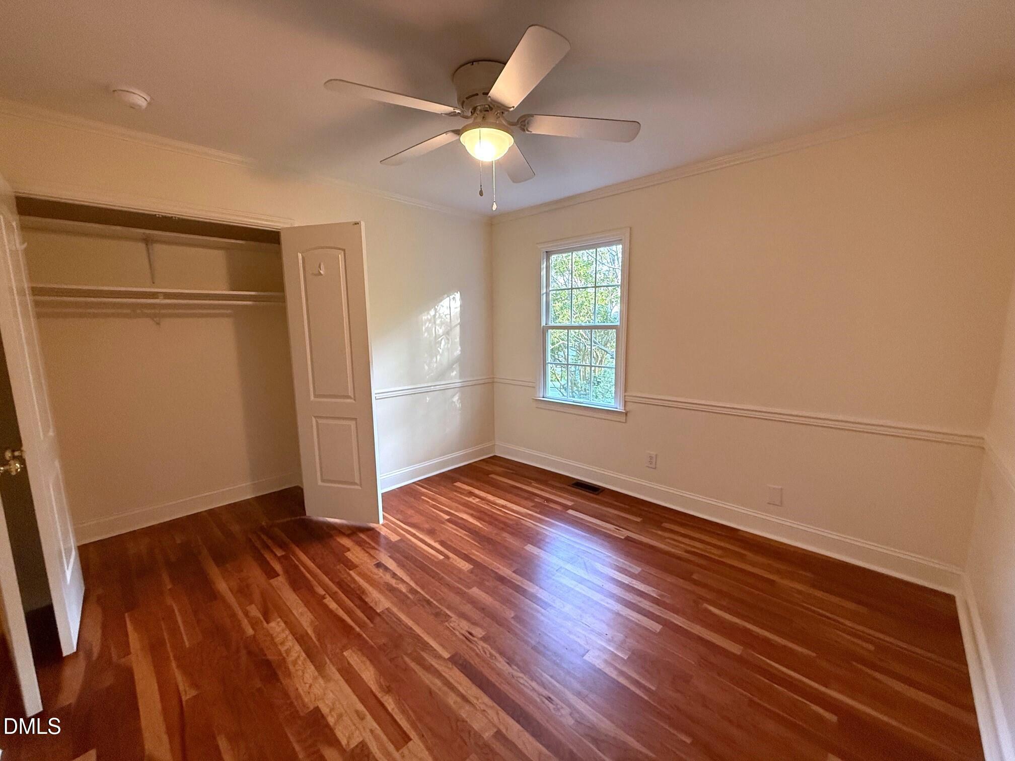 4108 Pleasant Grove Church Road Raleigh, NC 27613 - Photo 23 of 38 an empty room with wooden floor fan and windows