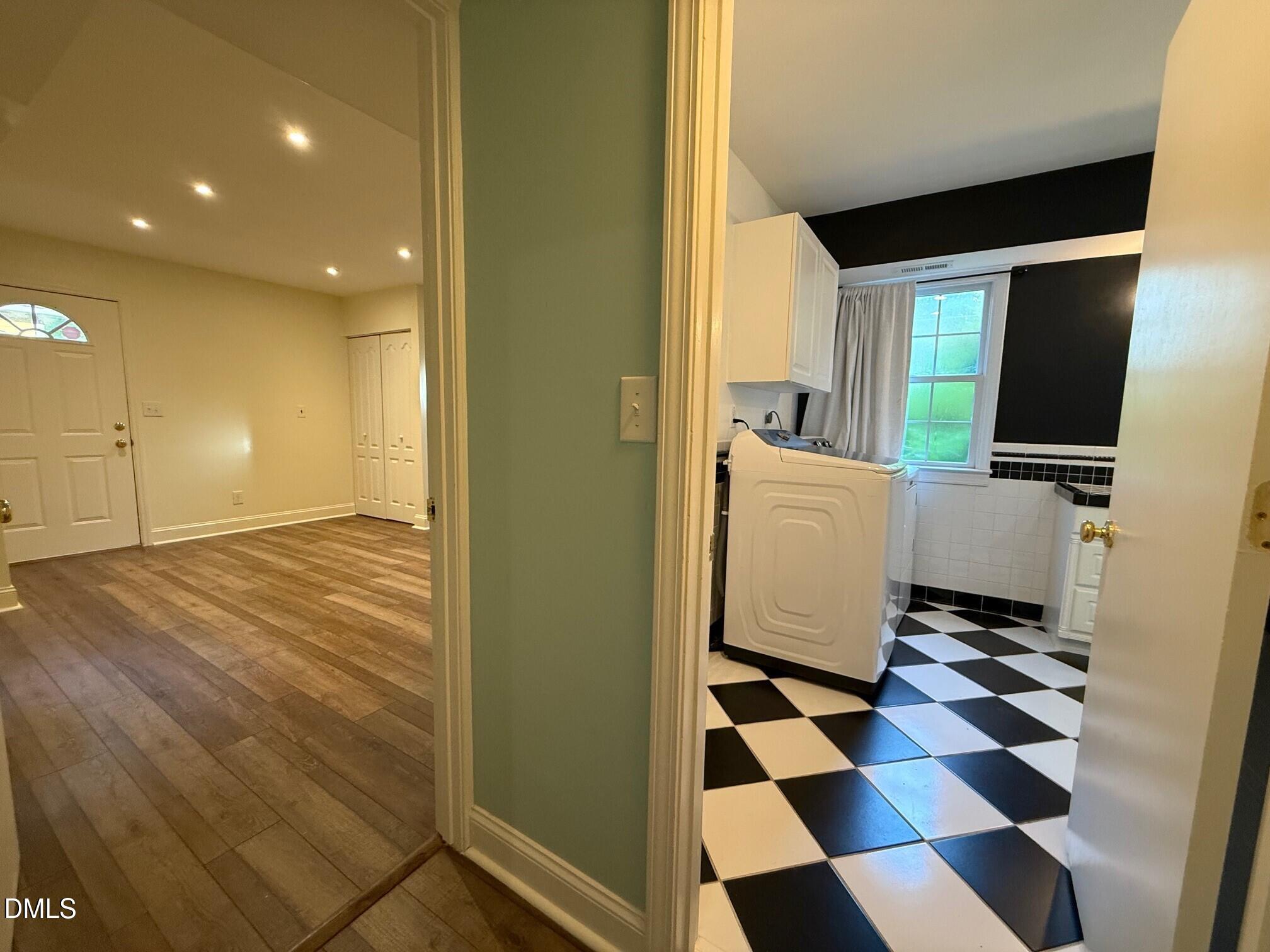 4108 Pleasant Grove Church Road Raleigh, NC 27613 - Photo 28 of 38 a room with a black white checkered floor with a gaming machine and a sink