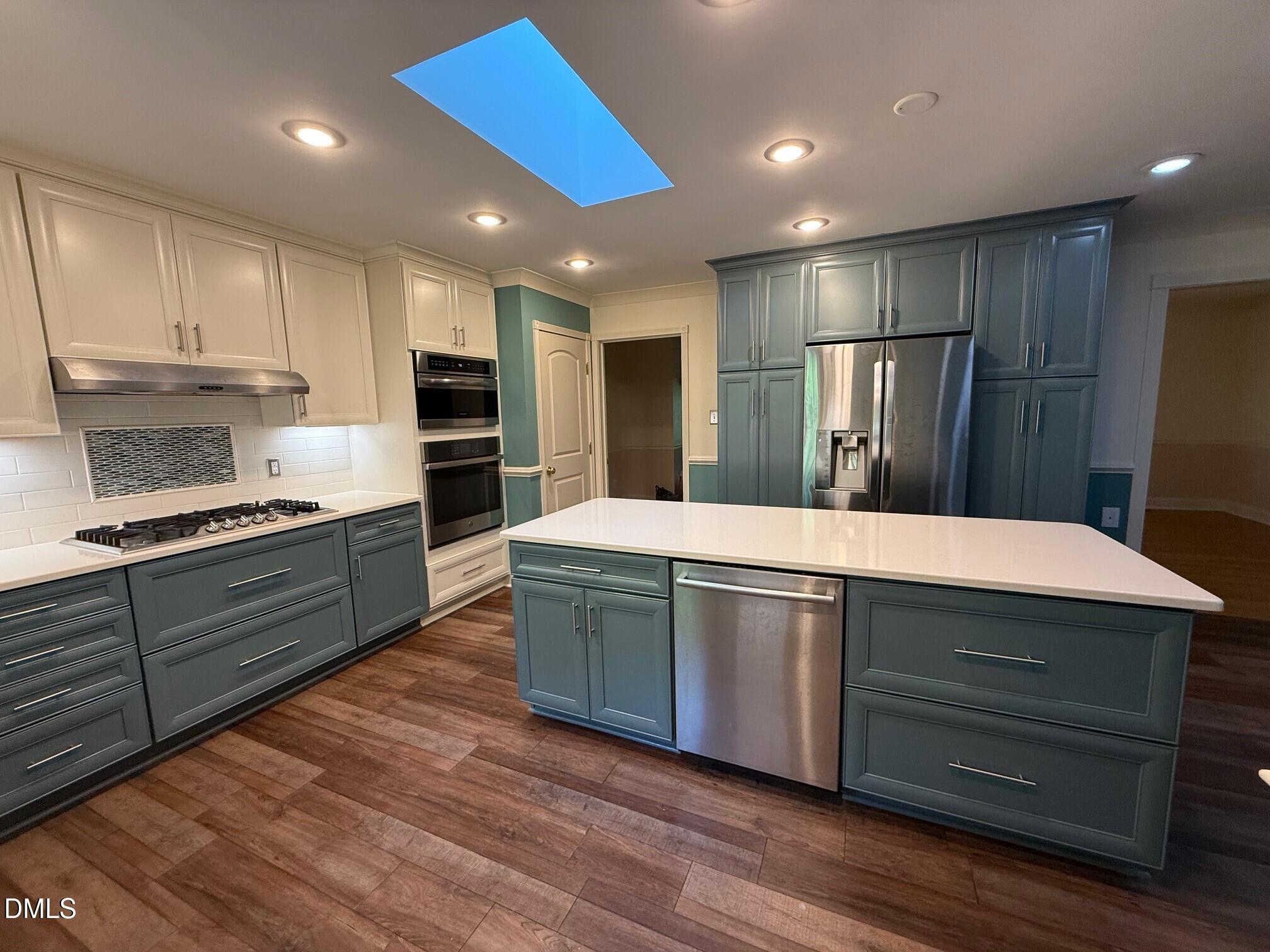 4108 Pleasant Grove Church Road Raleigh, NC 27613 - Photo 3 of 38 a kitchen with stainless steel appliances kitchen island granite countertop a refrigerator and a stove top oven