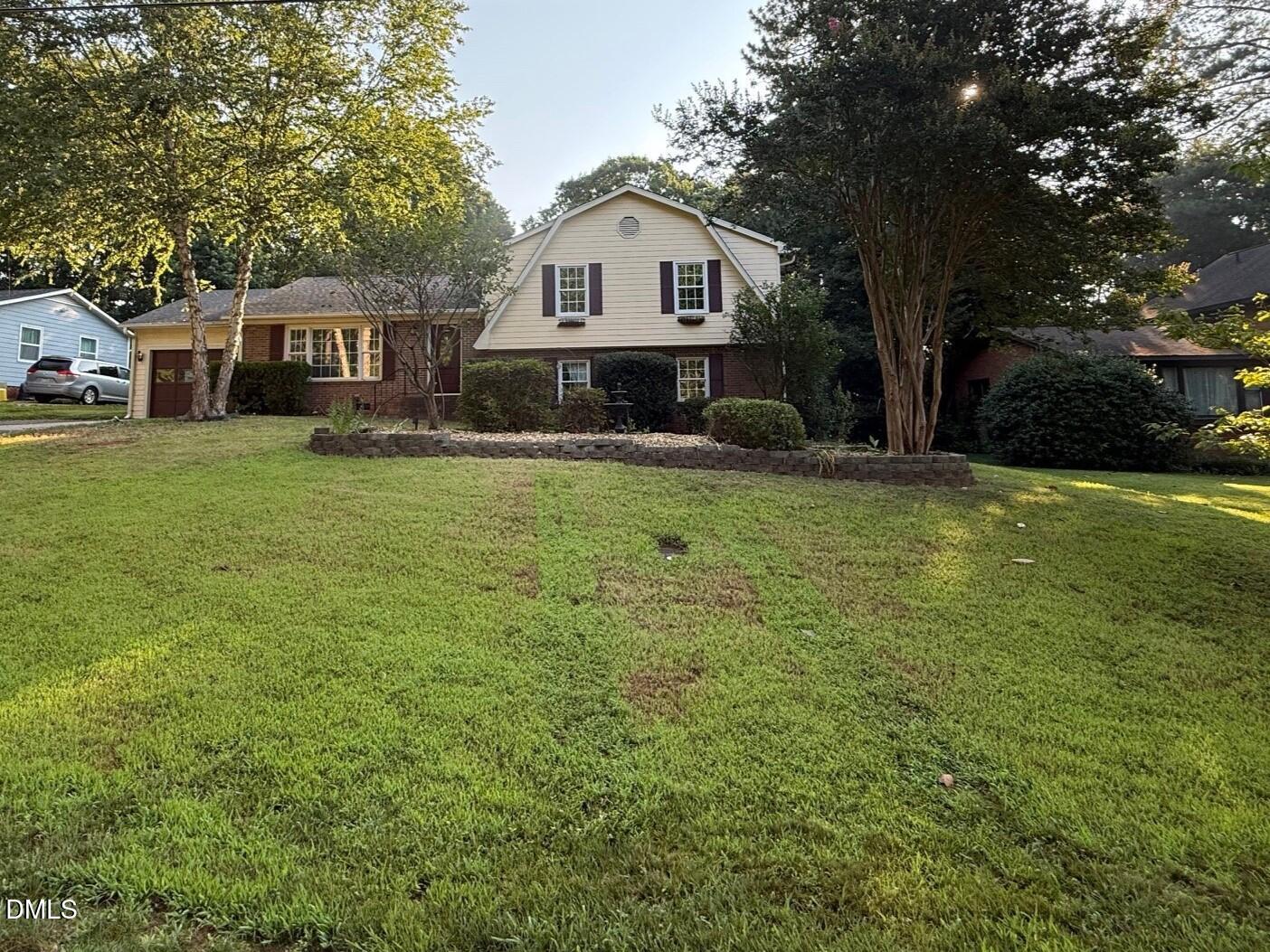 4108 Pleasant Grove Church Road Raleigh, NC 27613 - Photo 34 of 38 a front view of a house with a garden and trees