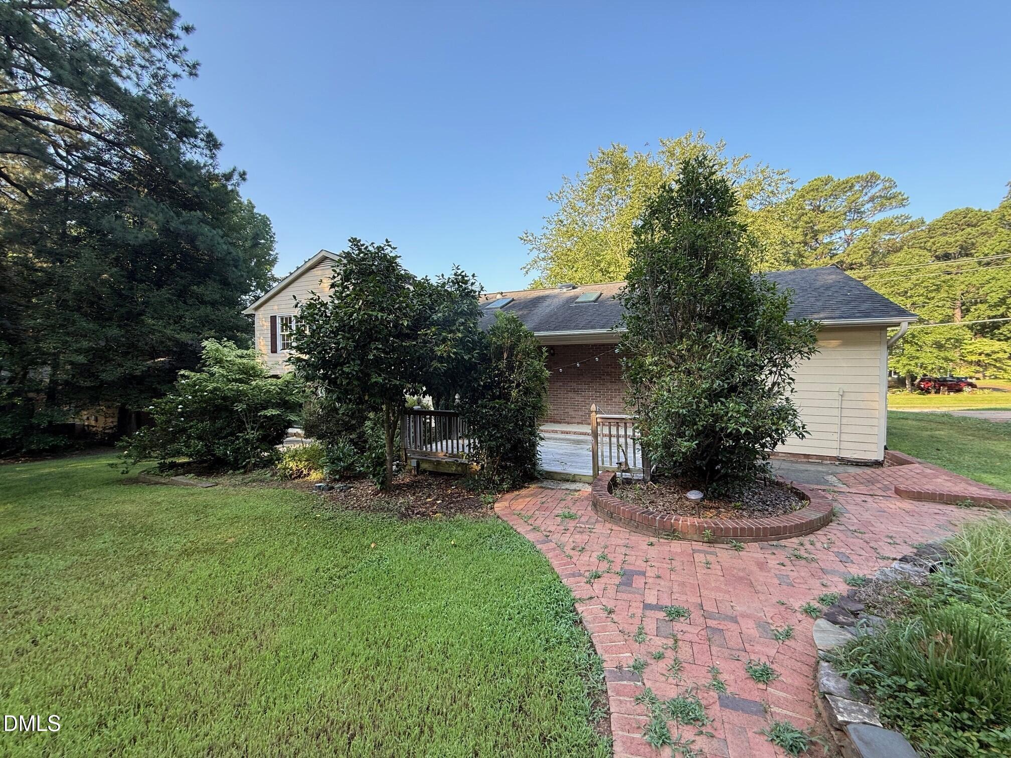 4108 Pleasant Grove Church Road Raleigh, NC 27613 - Photo 35 of 38 a front view of a house with a yard and potted plants