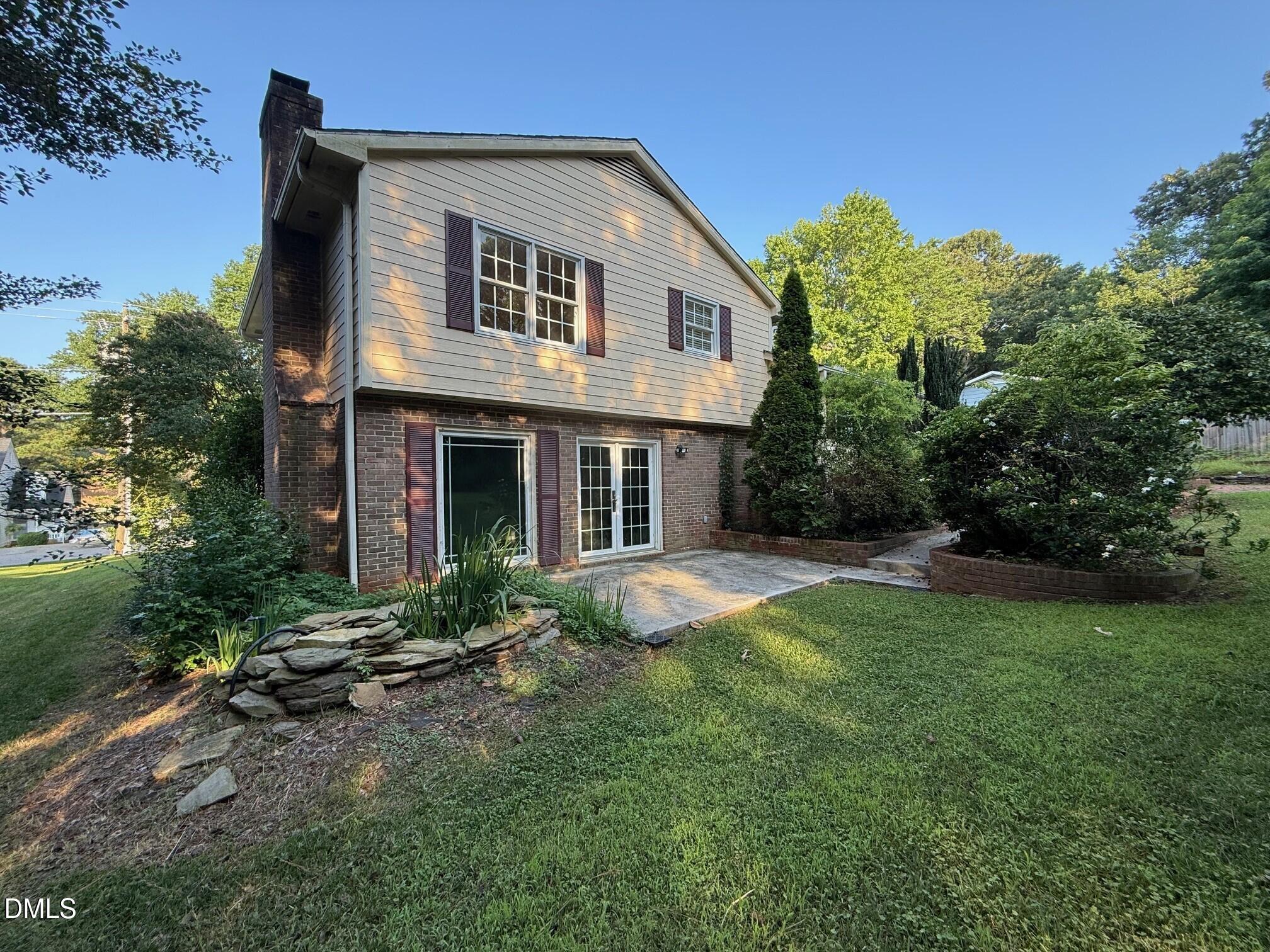 4108 Pleasant Grove Church Road Raleigh, NC 27613 - Photo 37 of 38 a front view of a house with a yard and trees