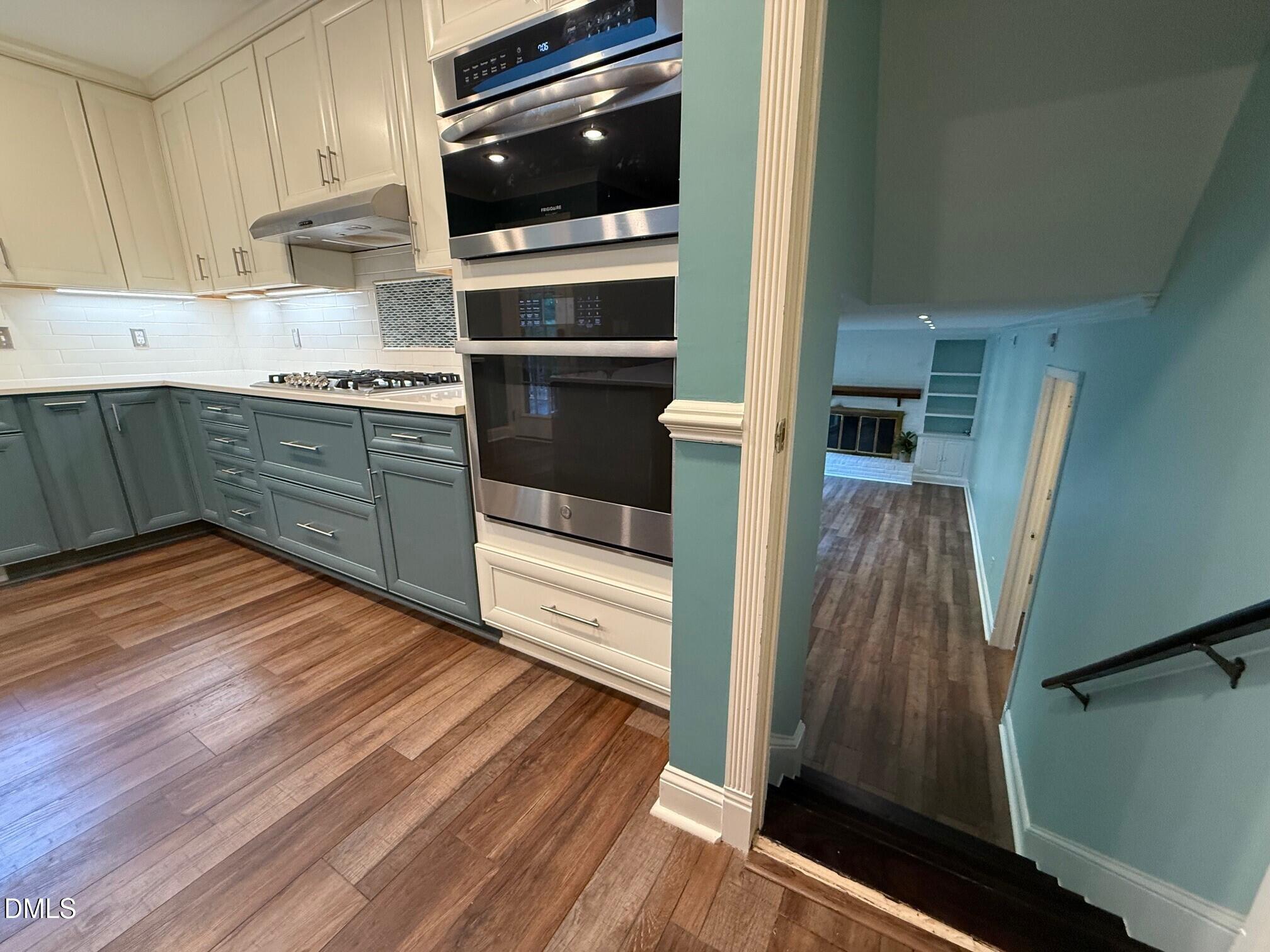 4108 Pleasant Grove Church Road Raleigh, NC 27613 - Photo 6 of 38 a kitchen with a wooden floor and a stove top oven