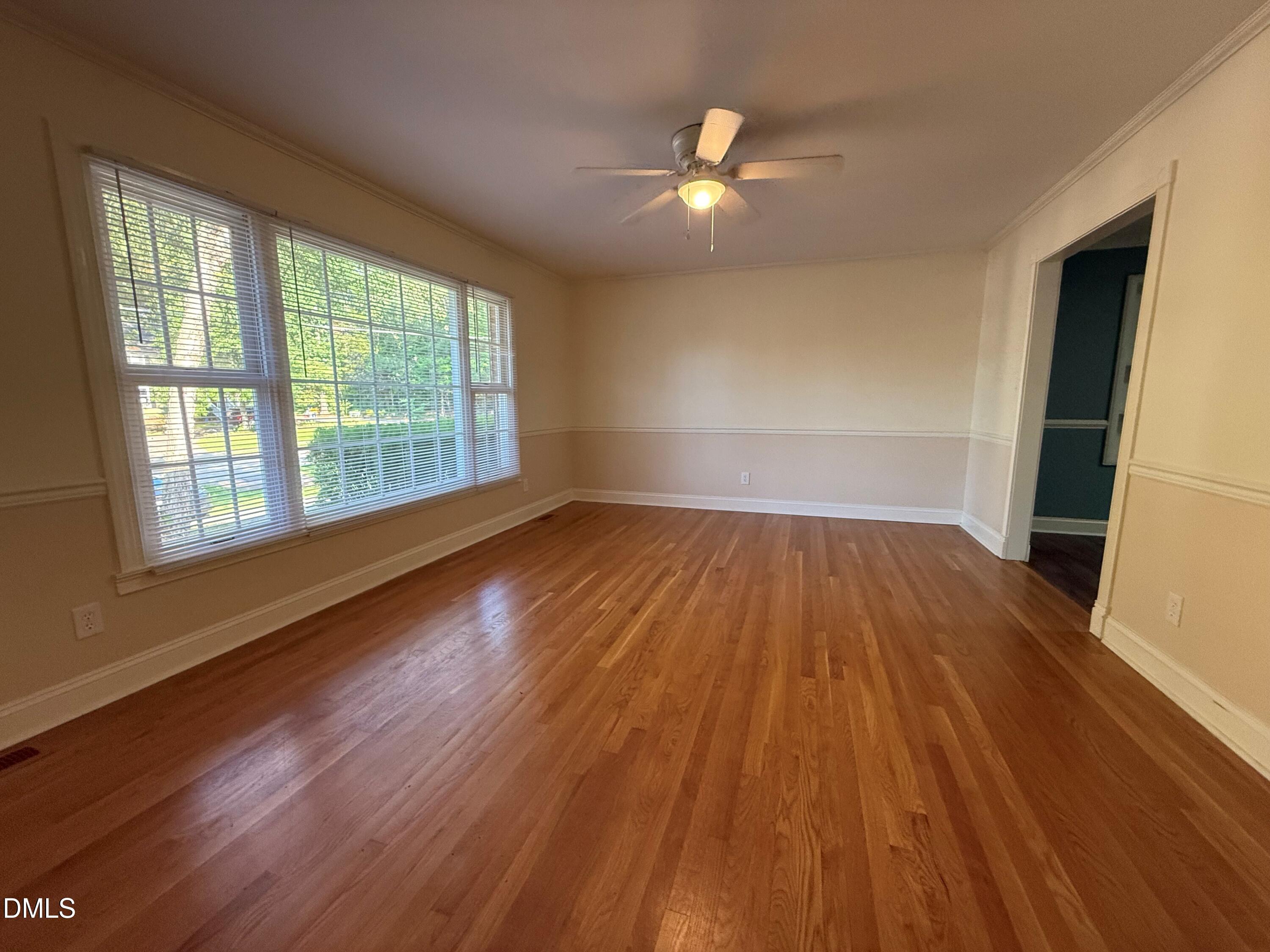 4108 Pleasant Grove Church Road Raleigh, NC 27613 - Photo 8 of 38 a view of empty room with wooden floor and fan