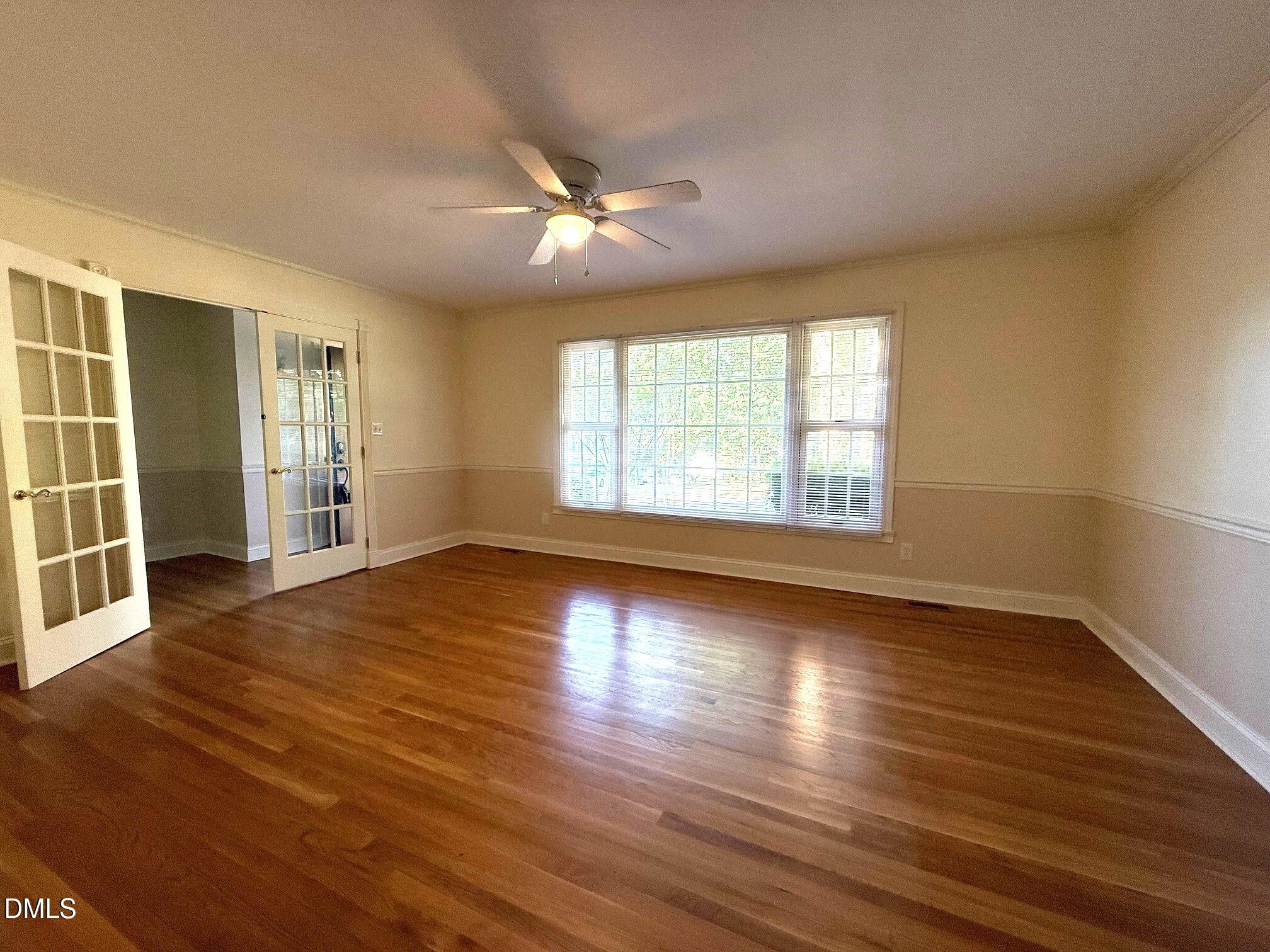 4108 Pleasant Grove Church Road Raleigh, NC 27613 - Photo 9 of 38 an empty room with wooden floor and windows