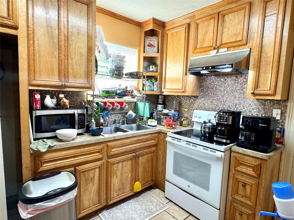 9105 Exeter Street Houston, TX 77093 - Photo 16 of 21 a kitchen with stainless steel appliances granite countertop a sink stove and cabinets