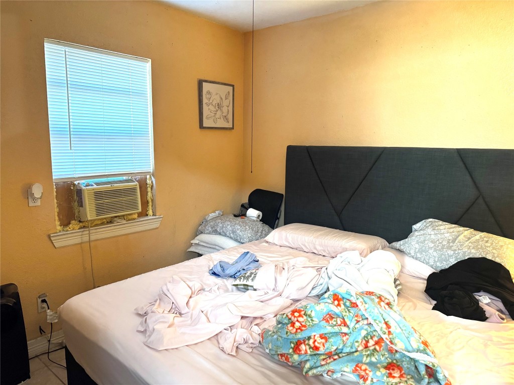 9105 Exeter Street Houston, TX 77093 - Photo 17 of 21 a bedroom with a bed and dresser