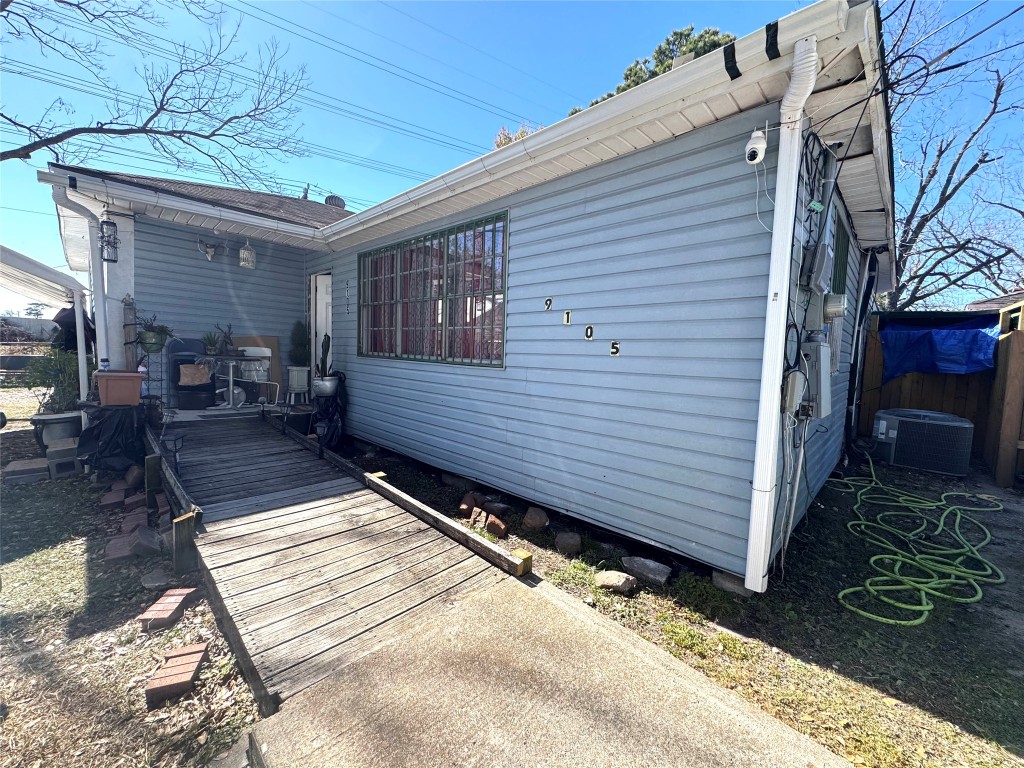 9105 Exeter Street Houston, TX 77093 - Photo 18 of 21 a view of a patio with a table and chairs next to a yard