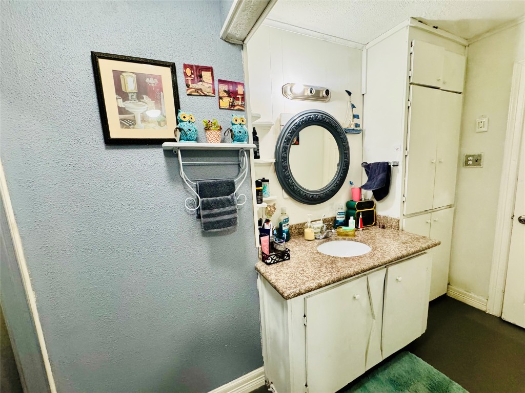 9105 Exeter Street Houston, TX 77093 - Photo 10 of 21 a bathroom with a granite countertop sink and a mirror