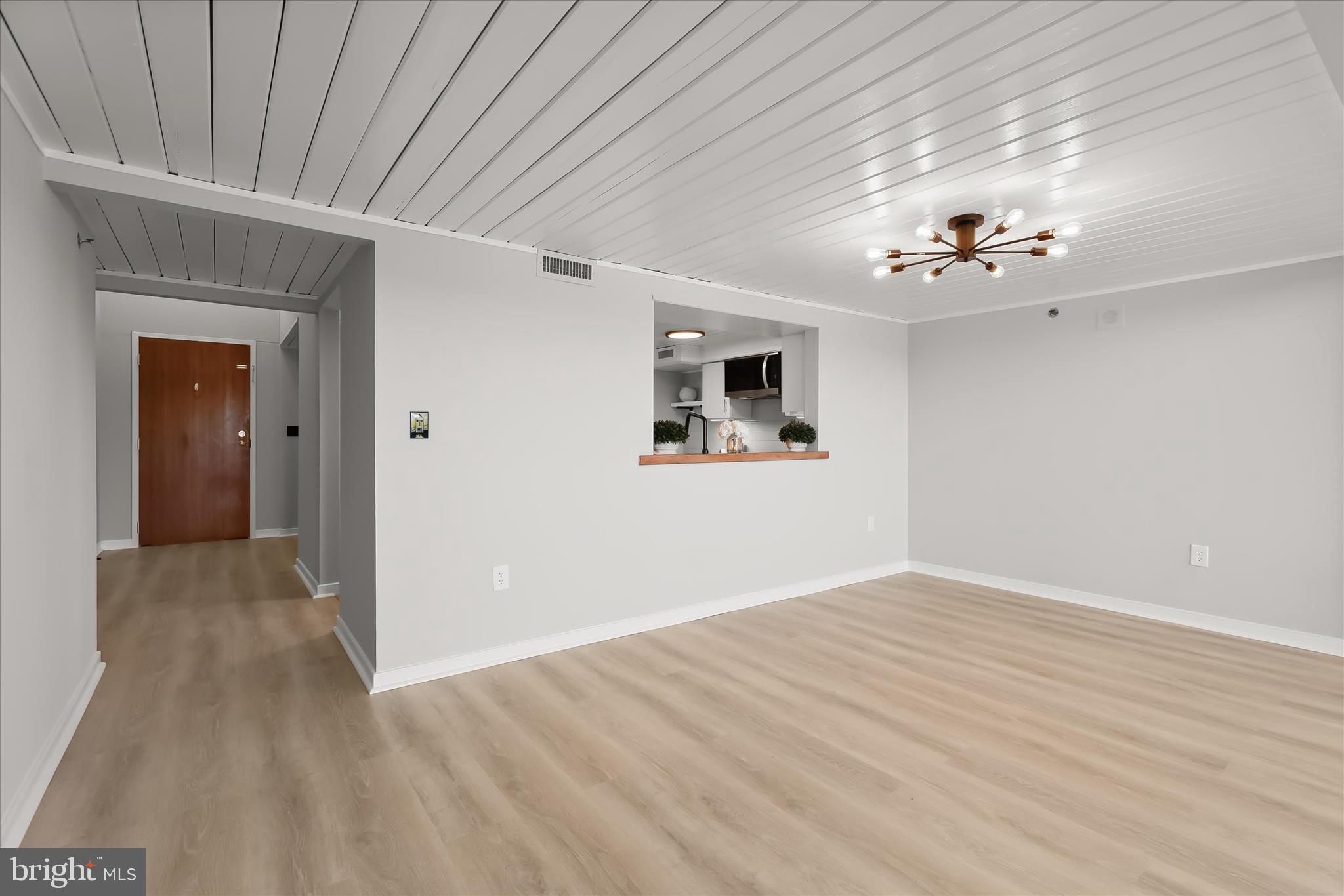 2901 Boston Street, Unit 302 Baltimore, MD 21224 - Photo 14 of 61 a view of a big room with wooden floor and windows