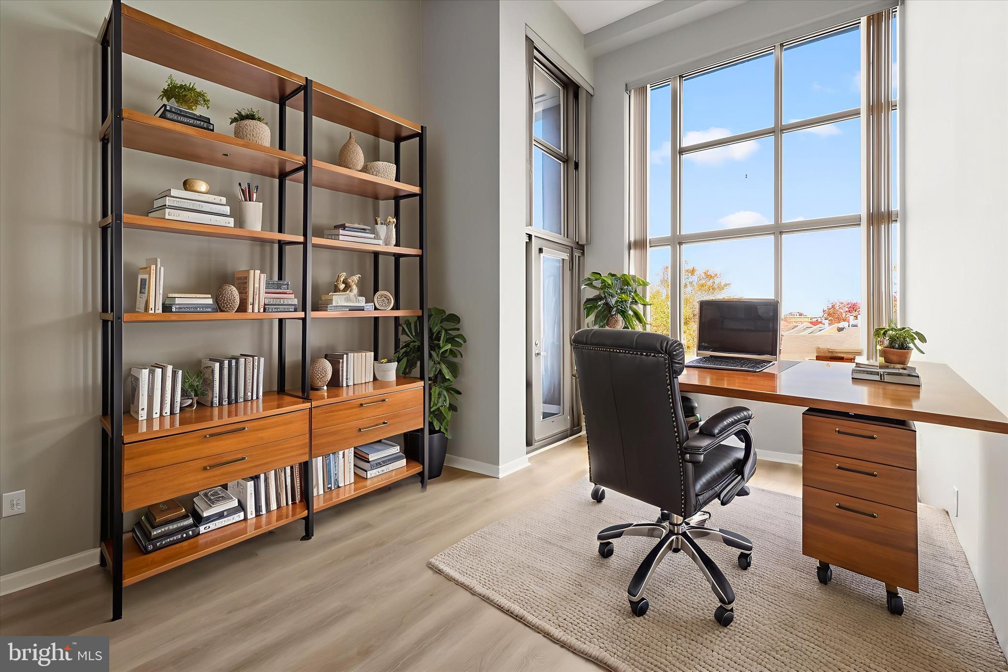 2901 Boston Street, Unit 302 Baltimore, MD 21224 - Photo 19 of 61 a view of a workspace with furniture and a window