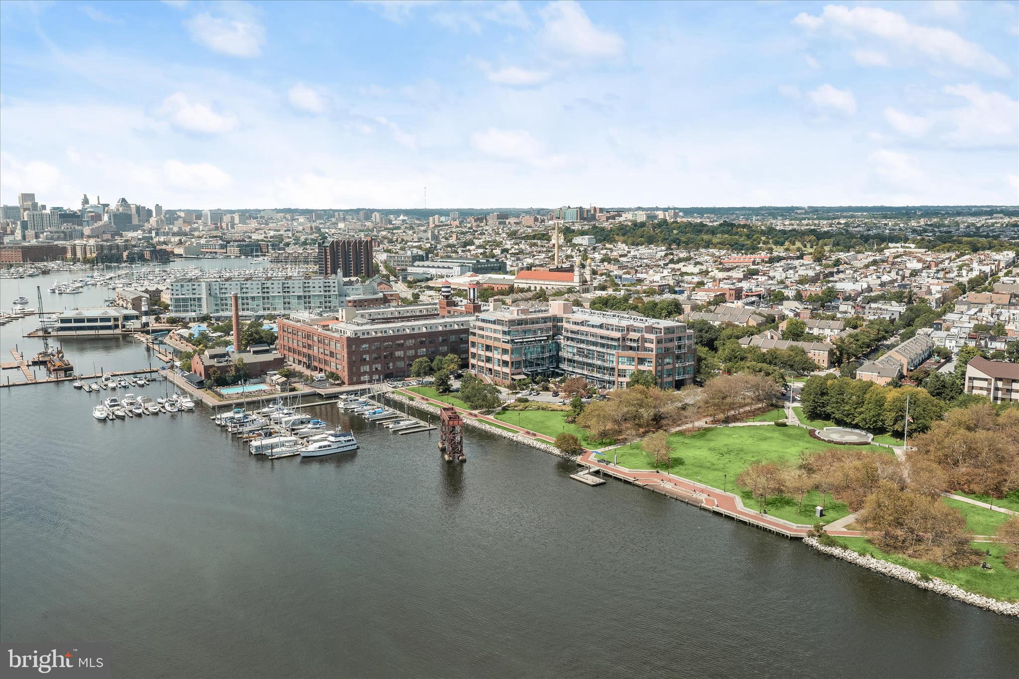 2901 Boston Street, Unit 302 Baltimore, MD 21224 - Photo 2 of 61 an aerial view of a city with lots of residential buildings ocean and mountain view in back