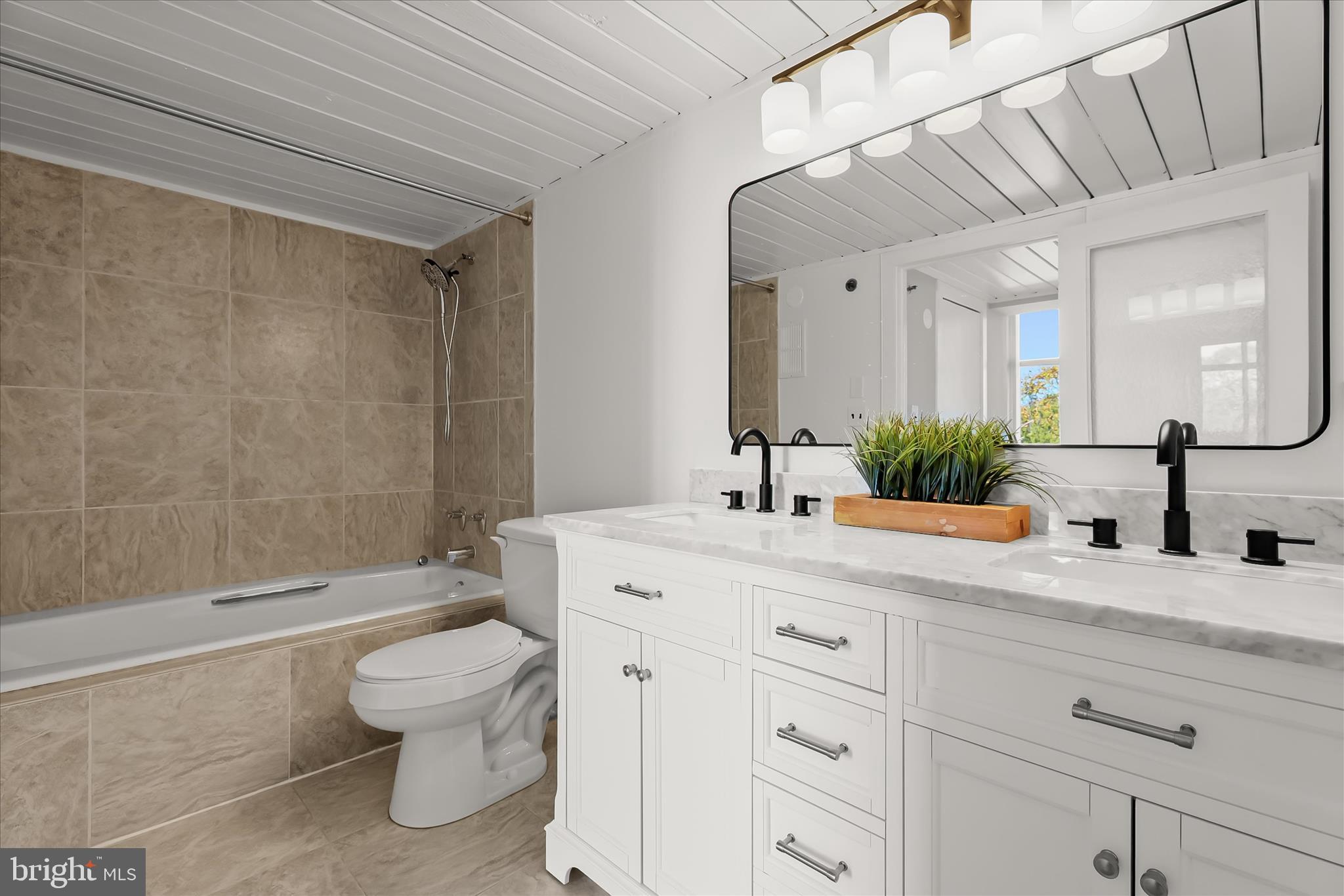 2901 Boston Street, Unit 302 Baltimore, MD 21224 - Photo 22 of 61 a bathroom with a granite countertop sink a toilet and shower