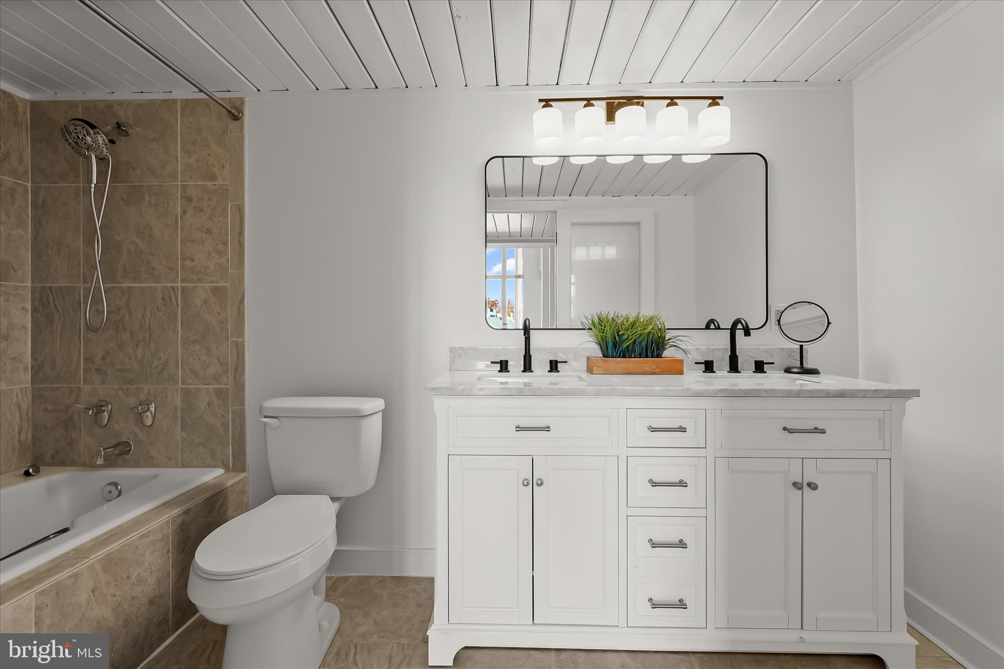 2901 Boston Street, Unit 302 Baltimore, MD 21224 - Photo 23 of 61 a bathroom with a toilet sink and mirror