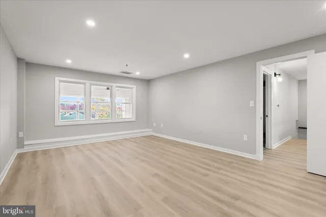 a bathroom with a toilet a sink a mirror and bathtub