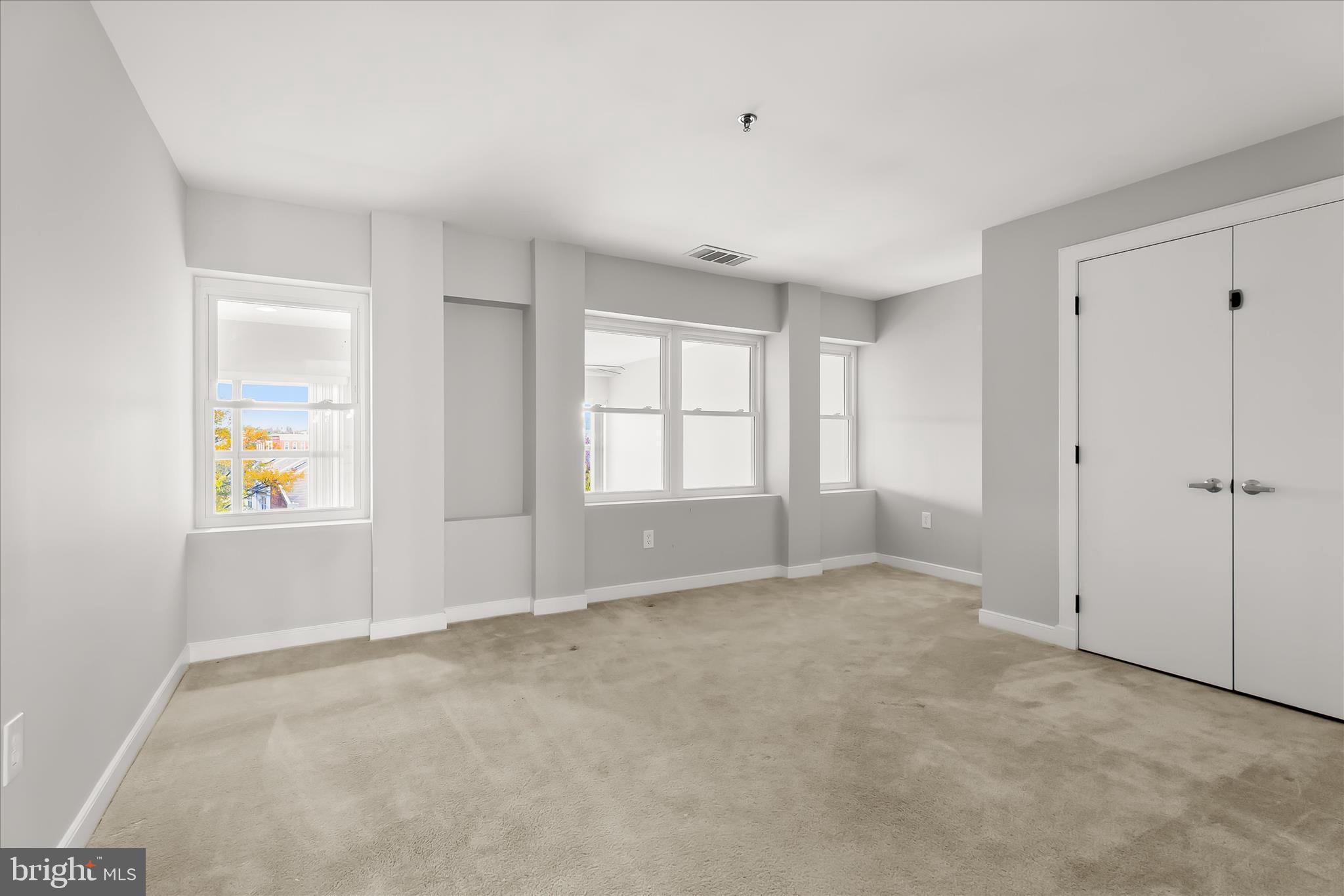 2901 Boston Street, Unit 302 Baltimore, MD 21224 - Photo 34 of 61 an empty room with windows