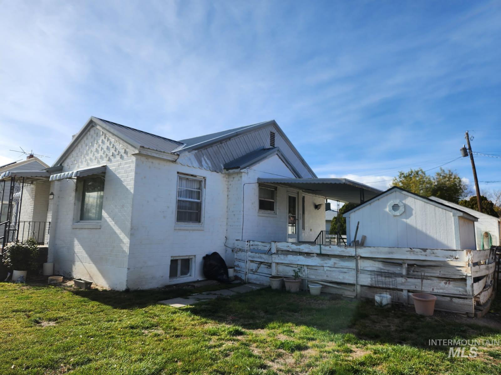 219 South 7th Street Nyssa, OR 97913 - Photo 23 of 29 View of home's exterior featuring a yard and a metal roof