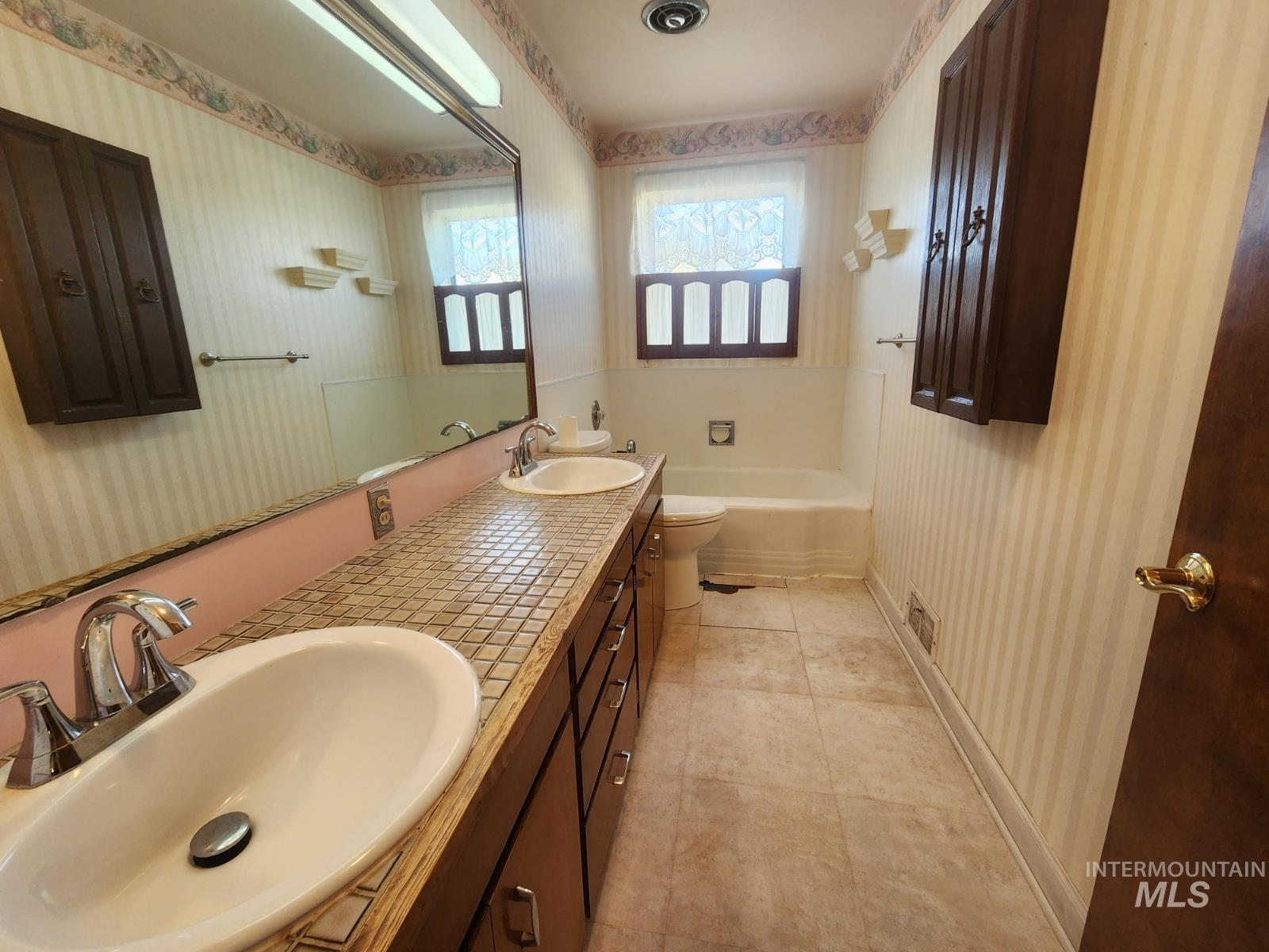 219 South 7th Street Nyssa, OR 97913 - Photo 6 of 29 Bathroom featuring wallpapered walls, double vanity, a bathtub, and light tile patterned floors