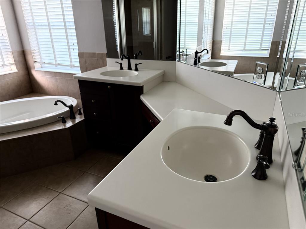 26601 Bull Run Leesburg, FL 34748 - Photo 11 of 15 a bathroom with a double vanity sink and a bathtub