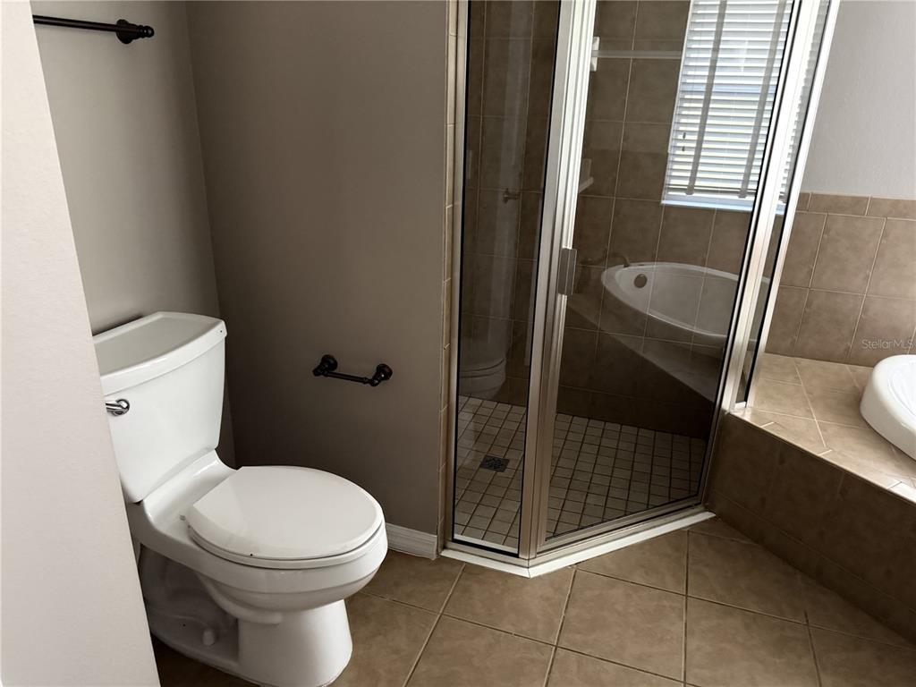 26601 Bull Run Leesburg, FL 34748 - Photo 12 of 15 a bathroom with a toilet and a shower