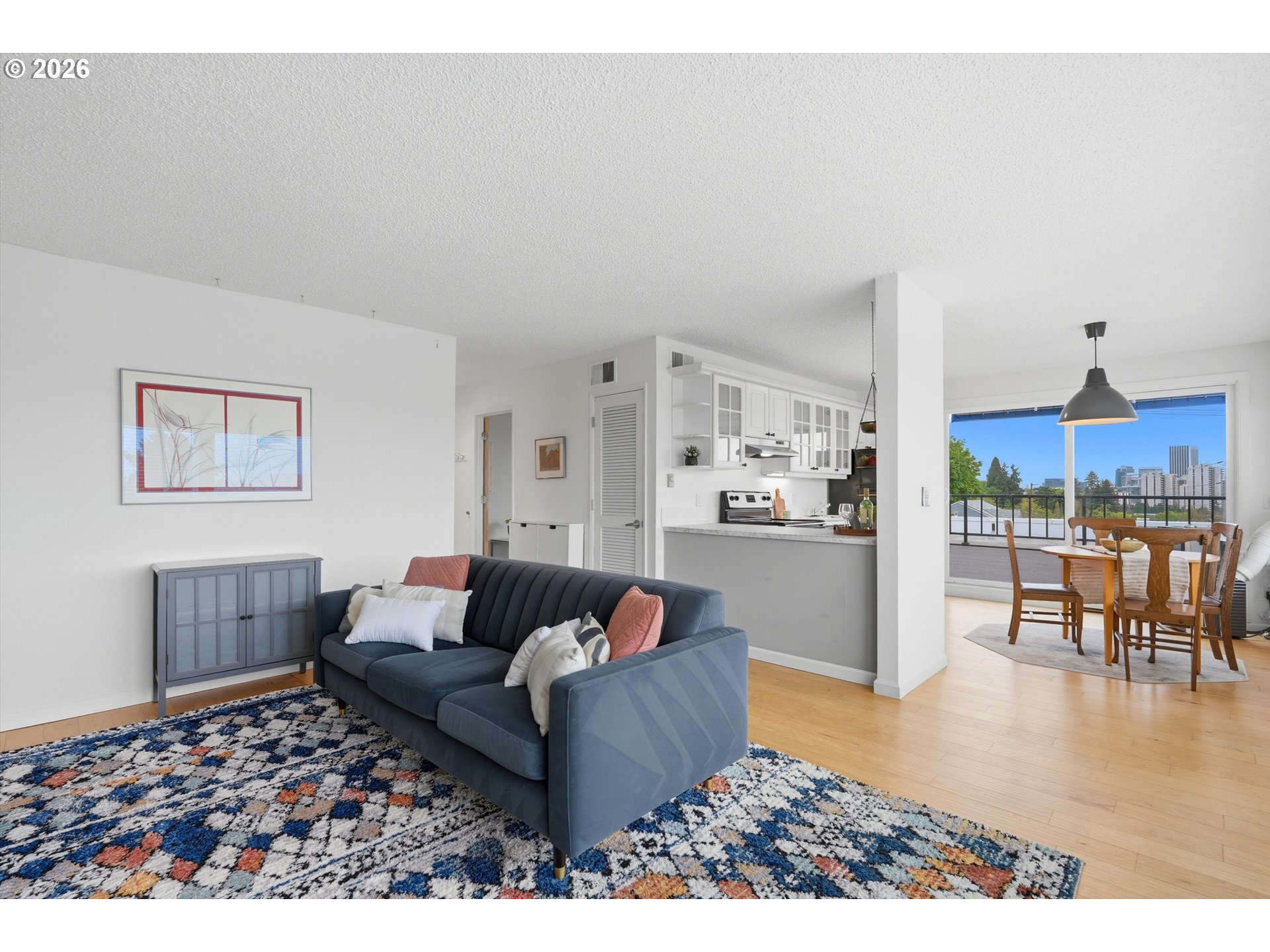 3515 Southwest Barbur Boulevard, Unit X3 Portland, OR 97239 - Photo 12 of 33 a living room with furniture and a rug
