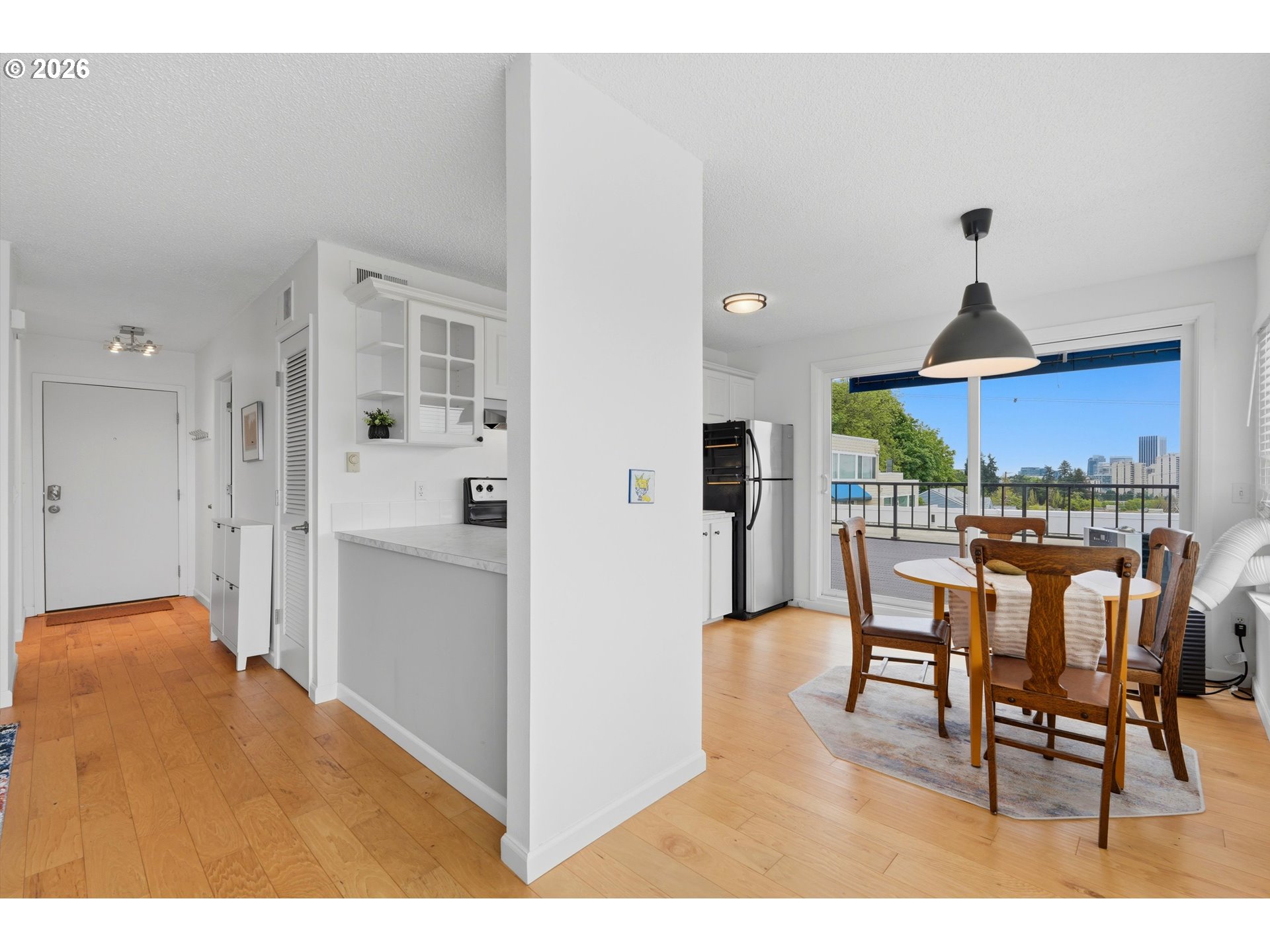 3515 Southwest Barbur Boulevard, Unit X3 Portland, OR 97239 - Photo 15 of 33 a open kitchen with stainless steel appliances kitchen island granite countertop a table and chairs