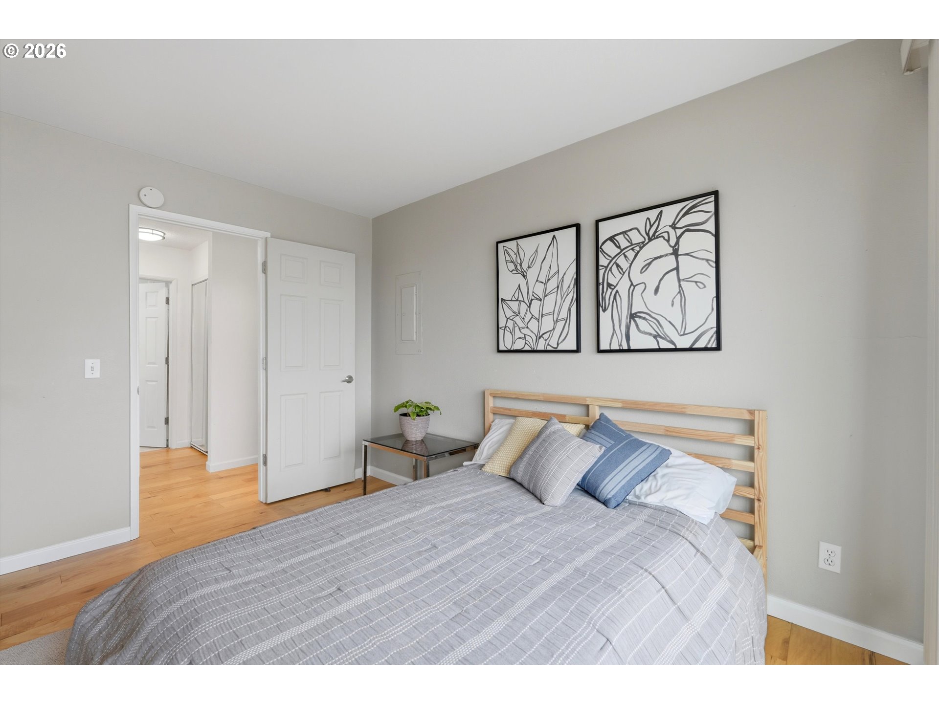 3515 Southwest Barbur Boulevard, Unit X3 Portland, OR 97239 - Photo 17 of 33 a bedroom with a bed and painting on the wall