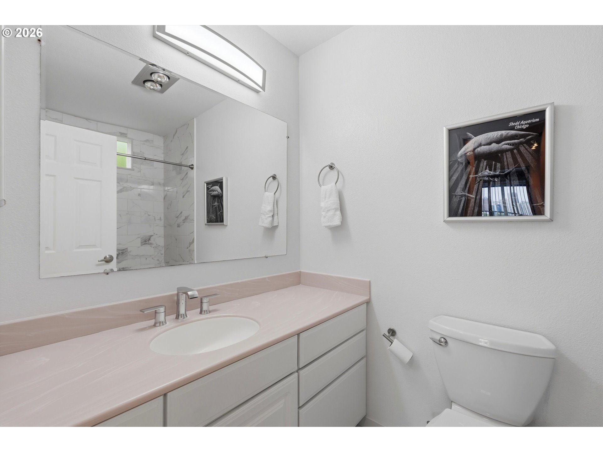 3515 Southwest Barbur Boulevard, Unit X3 Portland, OR 97239 - Photo 18 of 33 a bathroom with a sink a mirror and a toilet