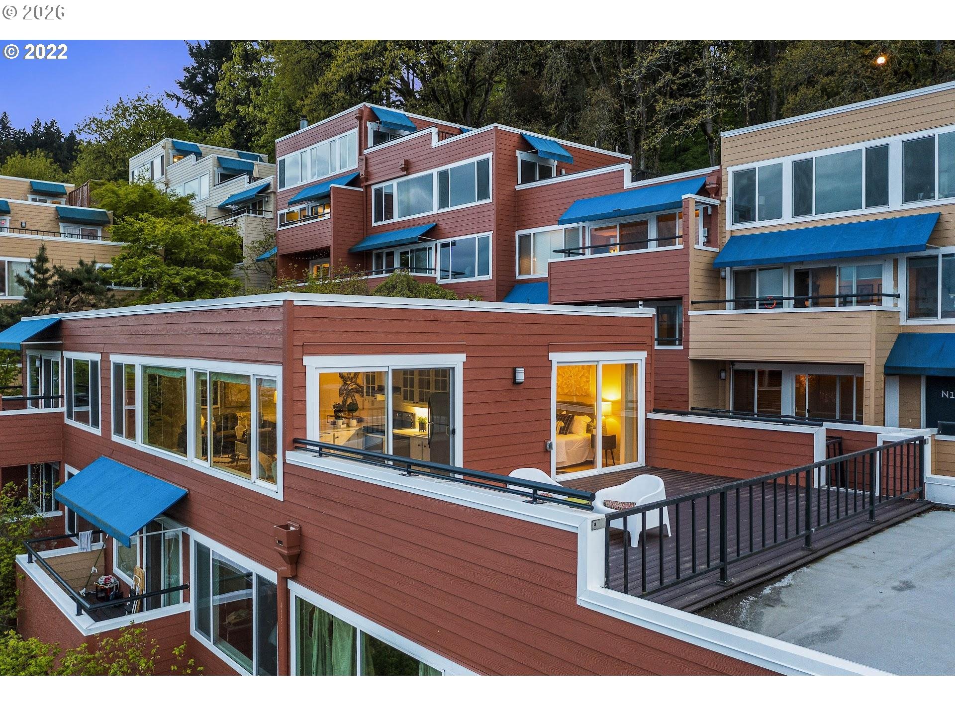 3515 Southwest Barbur Boulevard, Unit X3 Portland, OR 97239 - Photo 2 of 33 a front view of residential houses with deck and furniture