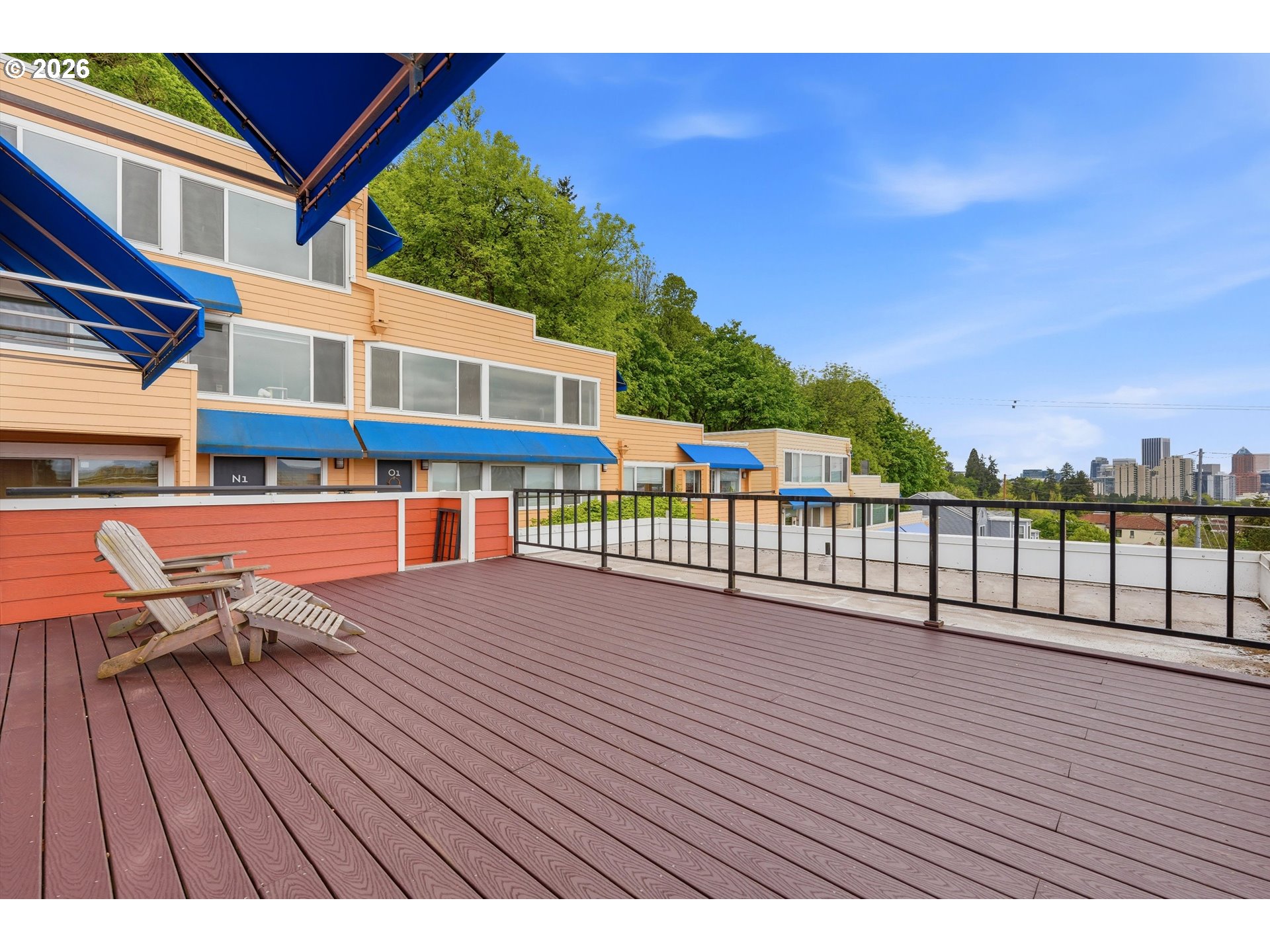 3515 Southwest Barbur Boulevard, Unit X3 Portland, OR 97239 - Photo 21 of 33 a view of a balcony with wooden floor and iron fence