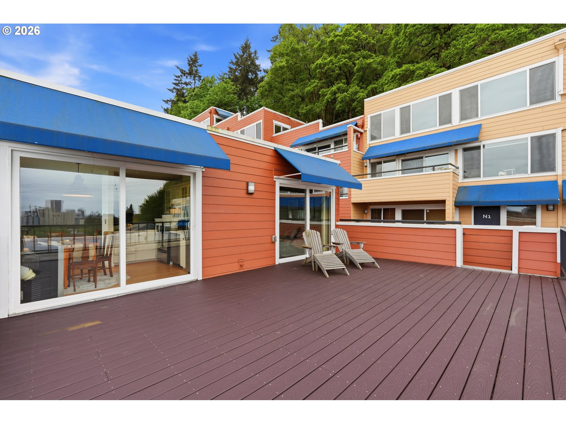 3515 Southwest Barbur Boulevard, Unit X3 Portland, OR 97239 - Photo 22 of 33 a view of an chairs and deck in front of a house