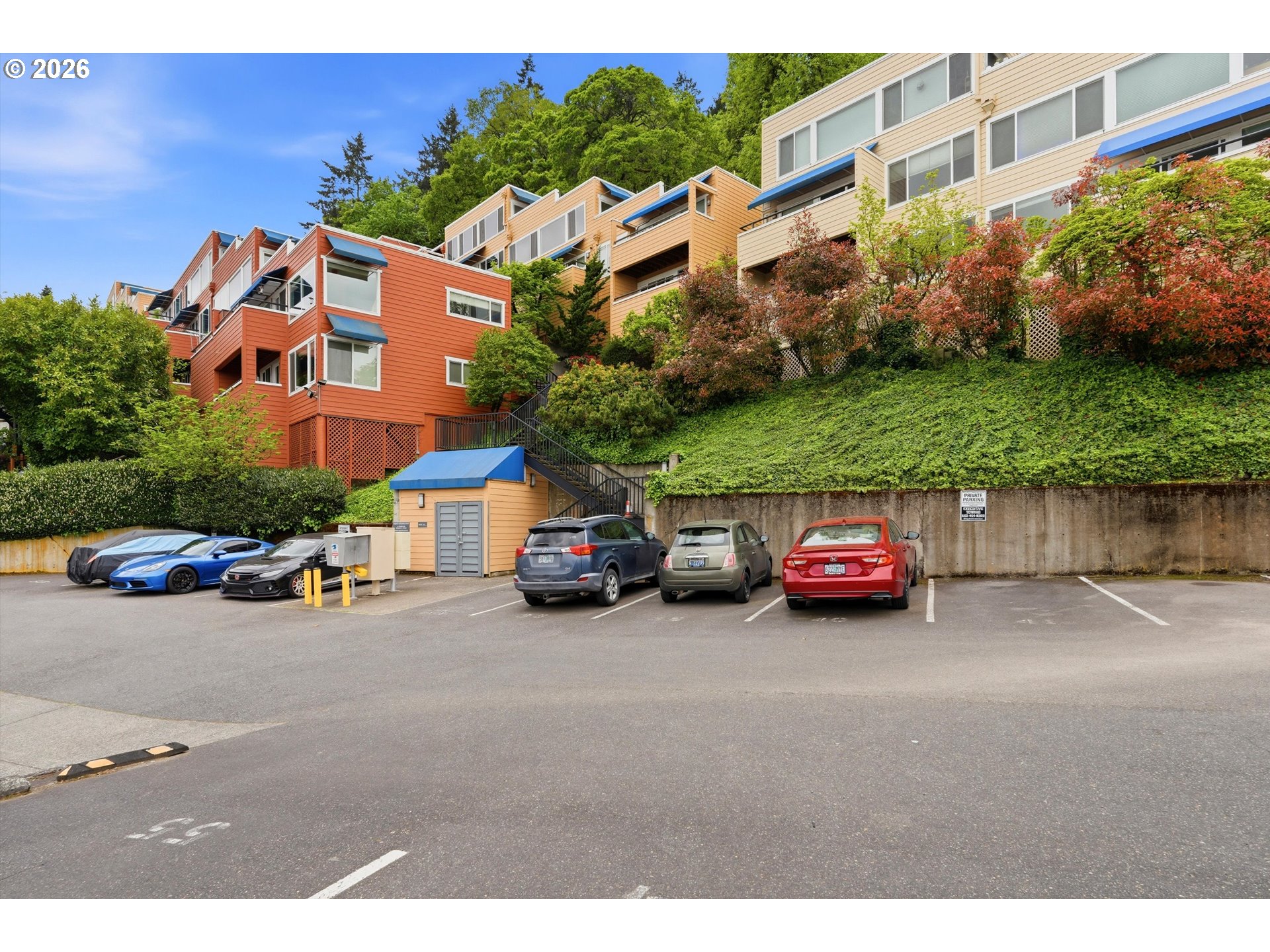 3515 Southwest Barbur Boulevard, Unit X3 Portland, OR 97239 - Photo 26 of 33 a view of a cars parked in front of a building