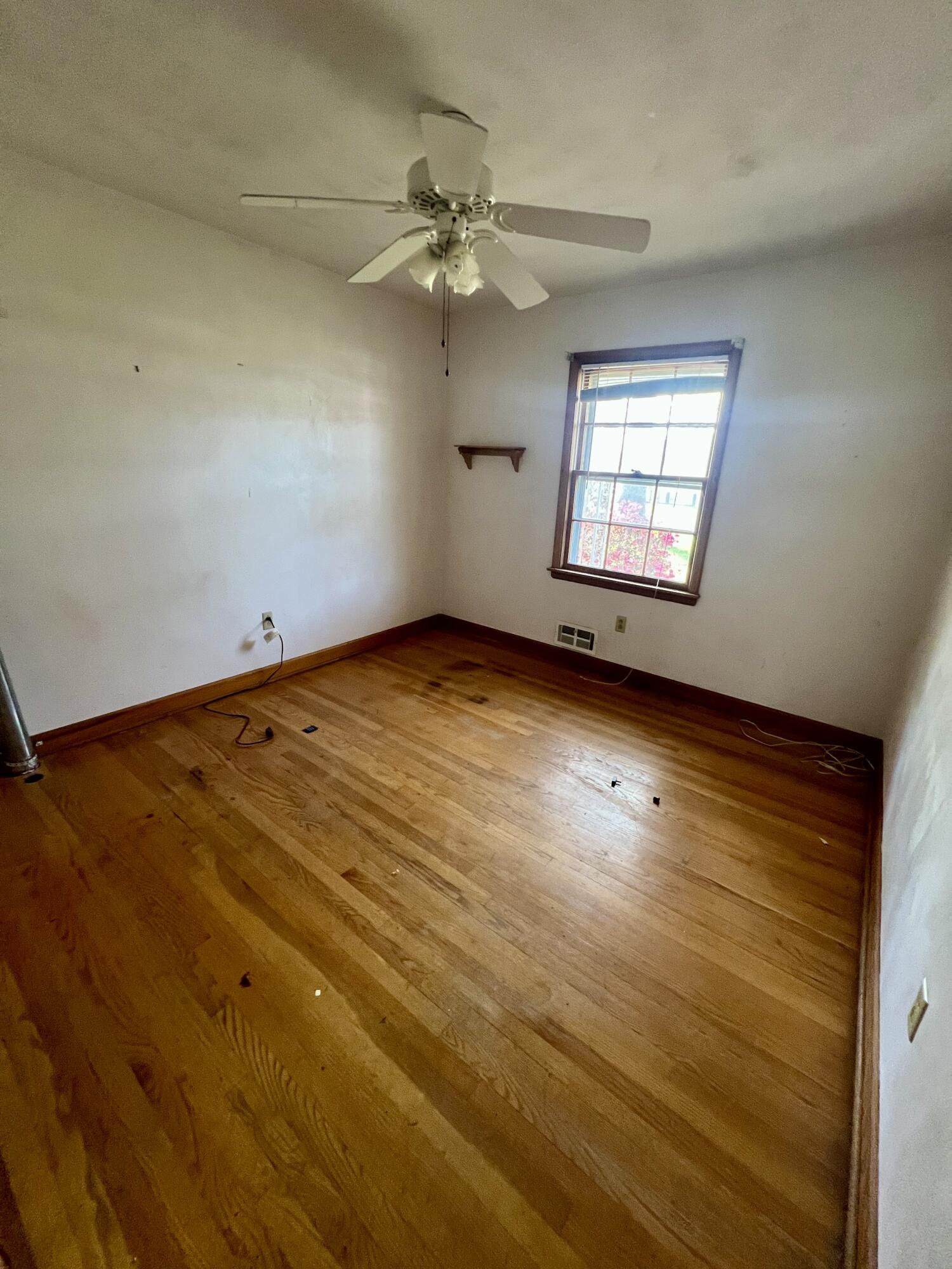 984 Colbourne Avenue Vinton, VA 24179 - Photo 12 of 22 an empty room with wooden floor fan and windows