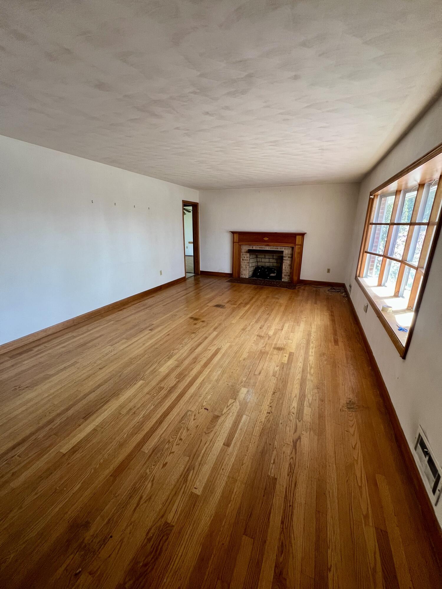 984 Colbourne Avenue Vinton, VA 24179 - Photo 7 of 22 wooden floor in an empty room with a window