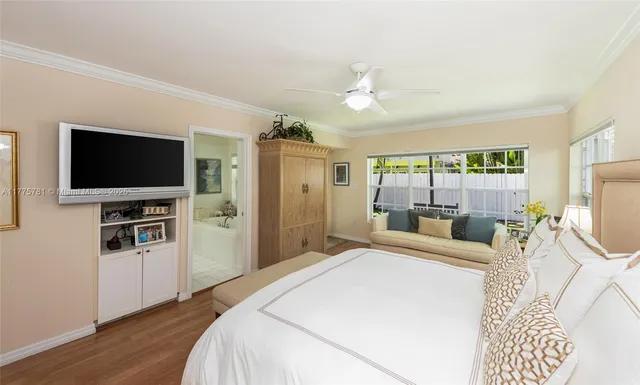 a bedroom with a flat screen tv and a bed