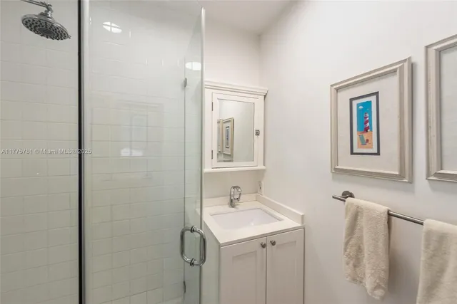 a bathroom with a sink a mirror and a shower