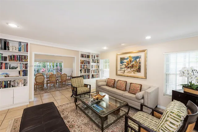 a living room with furniture and a book shelf