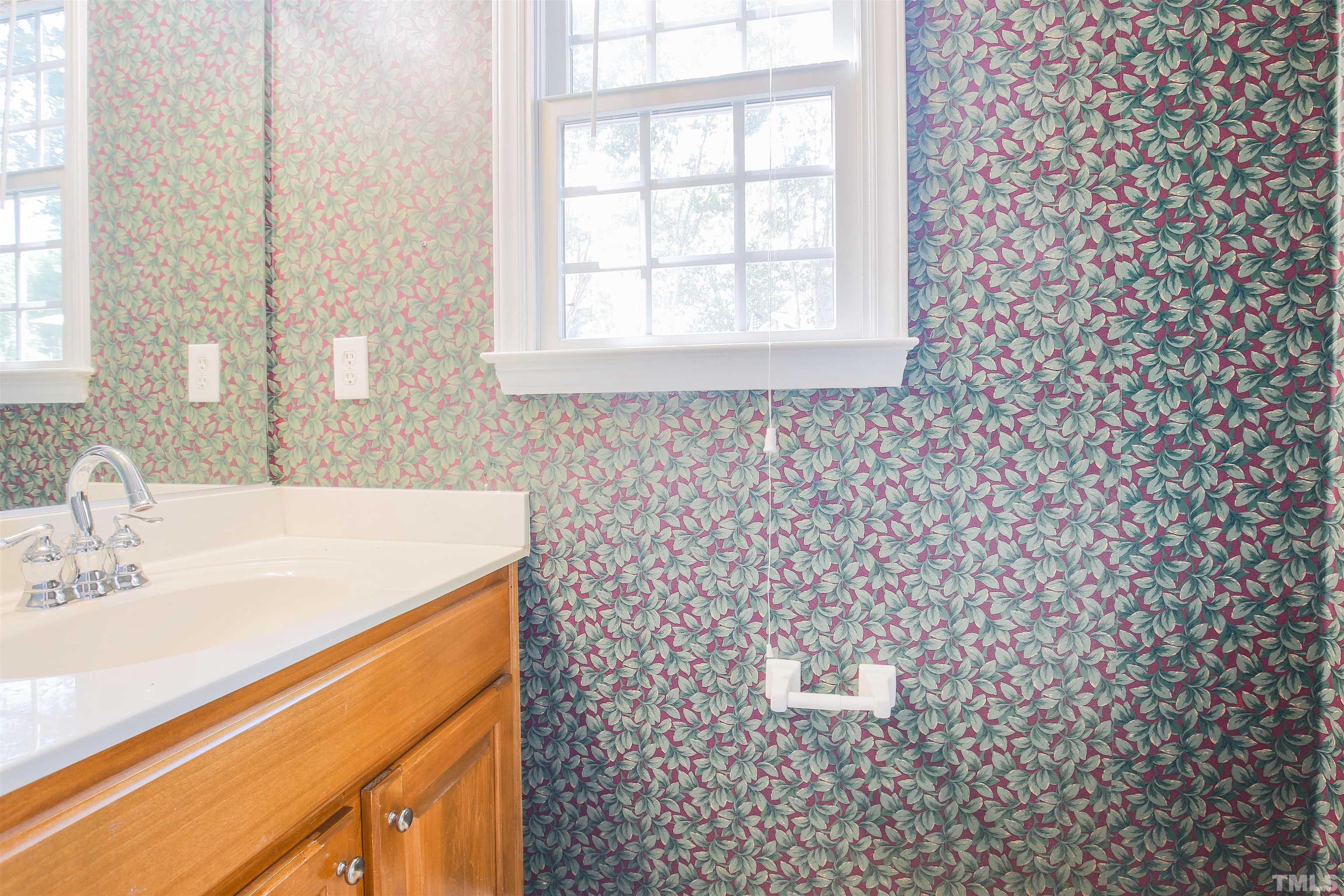 2305 Florida Court Raleigh, NC 27615 - Photo 18 of 24 a bathroom with a sink a toilet and a mirror