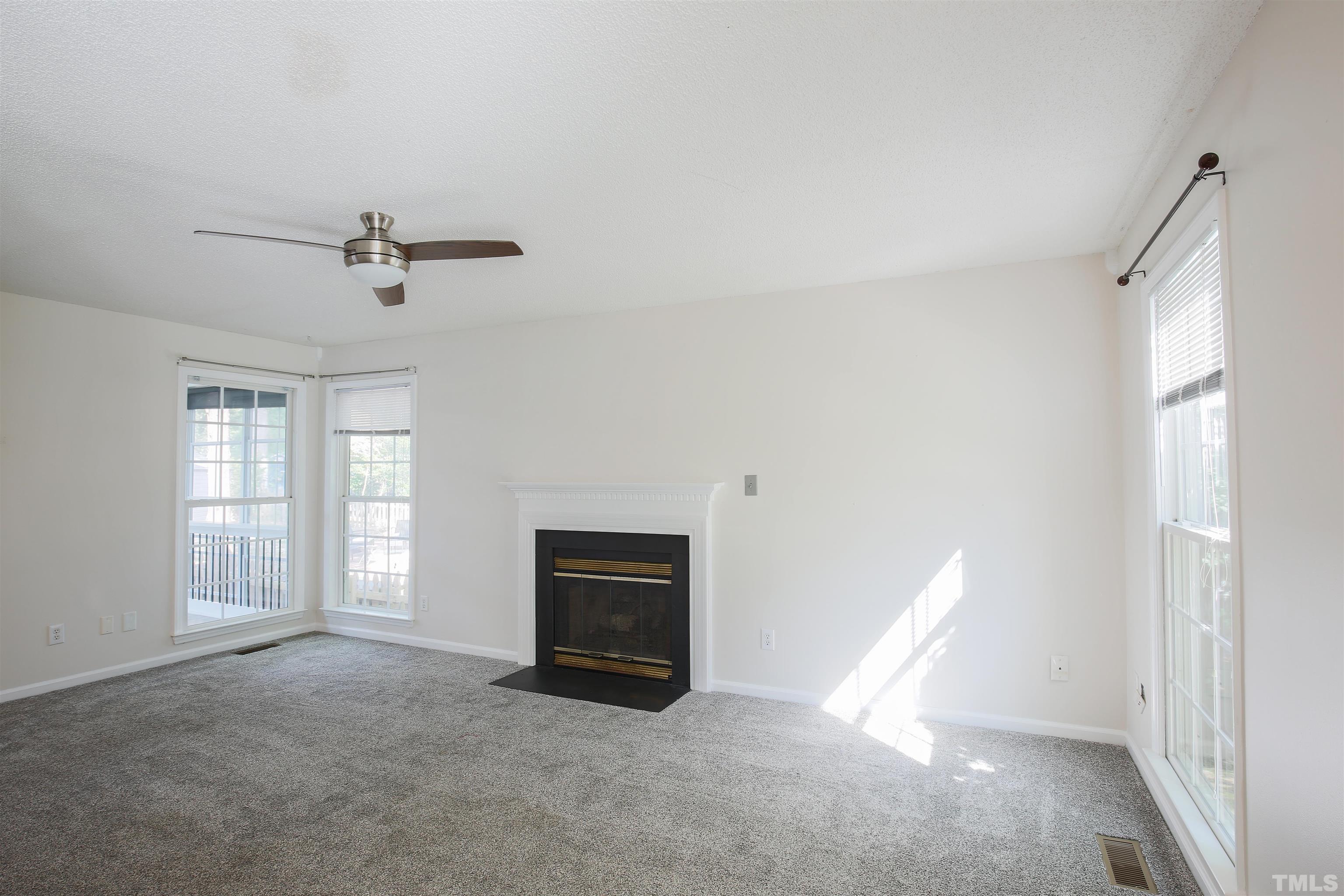 2305 Florida Court Raleigh, NC 27615 - Photo 3 of 24 an empty room with windows and fireplace