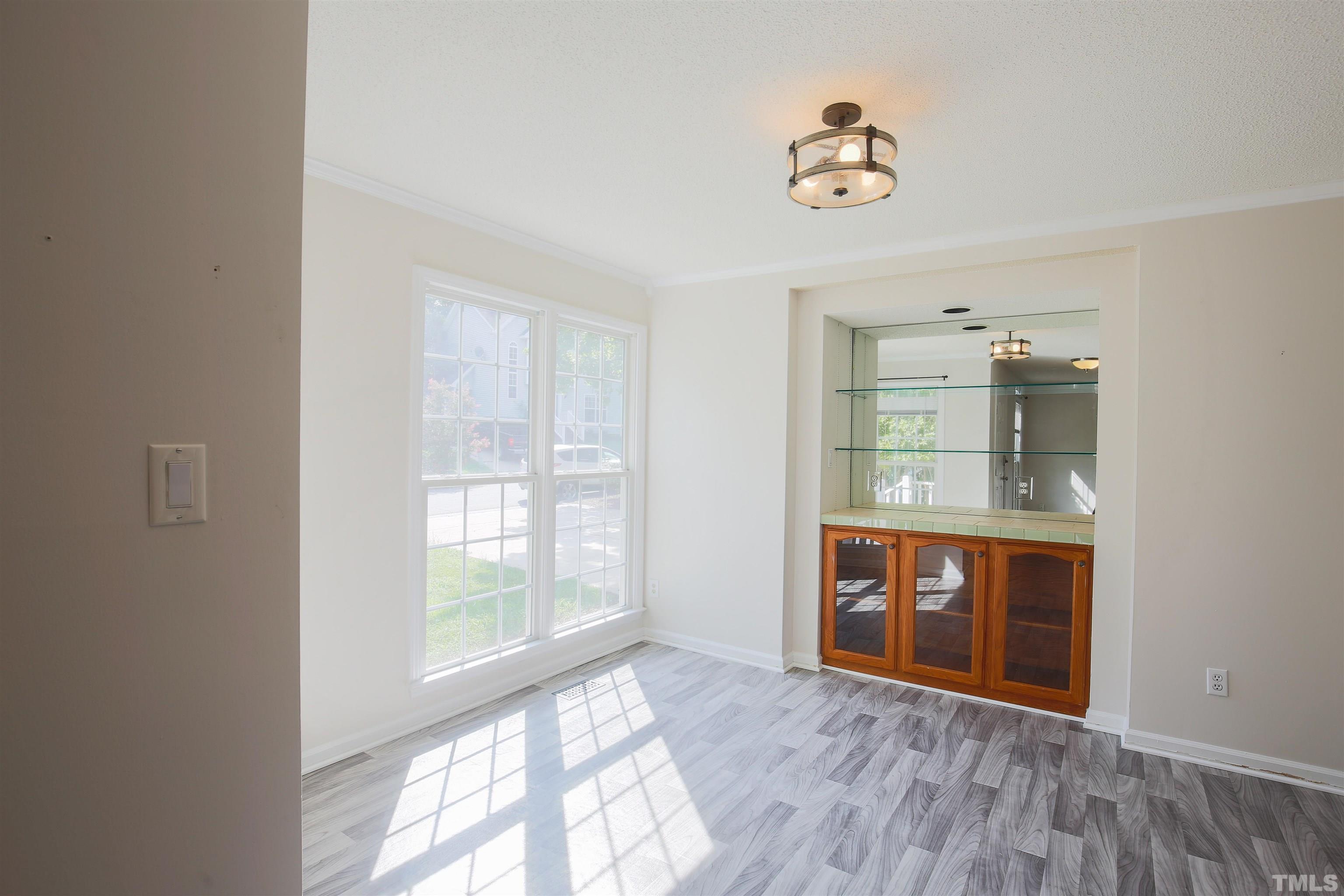 2305 Florida Court Raleigh, NC 27615 - Photo 8 of 24 a room with wooden floor and a window